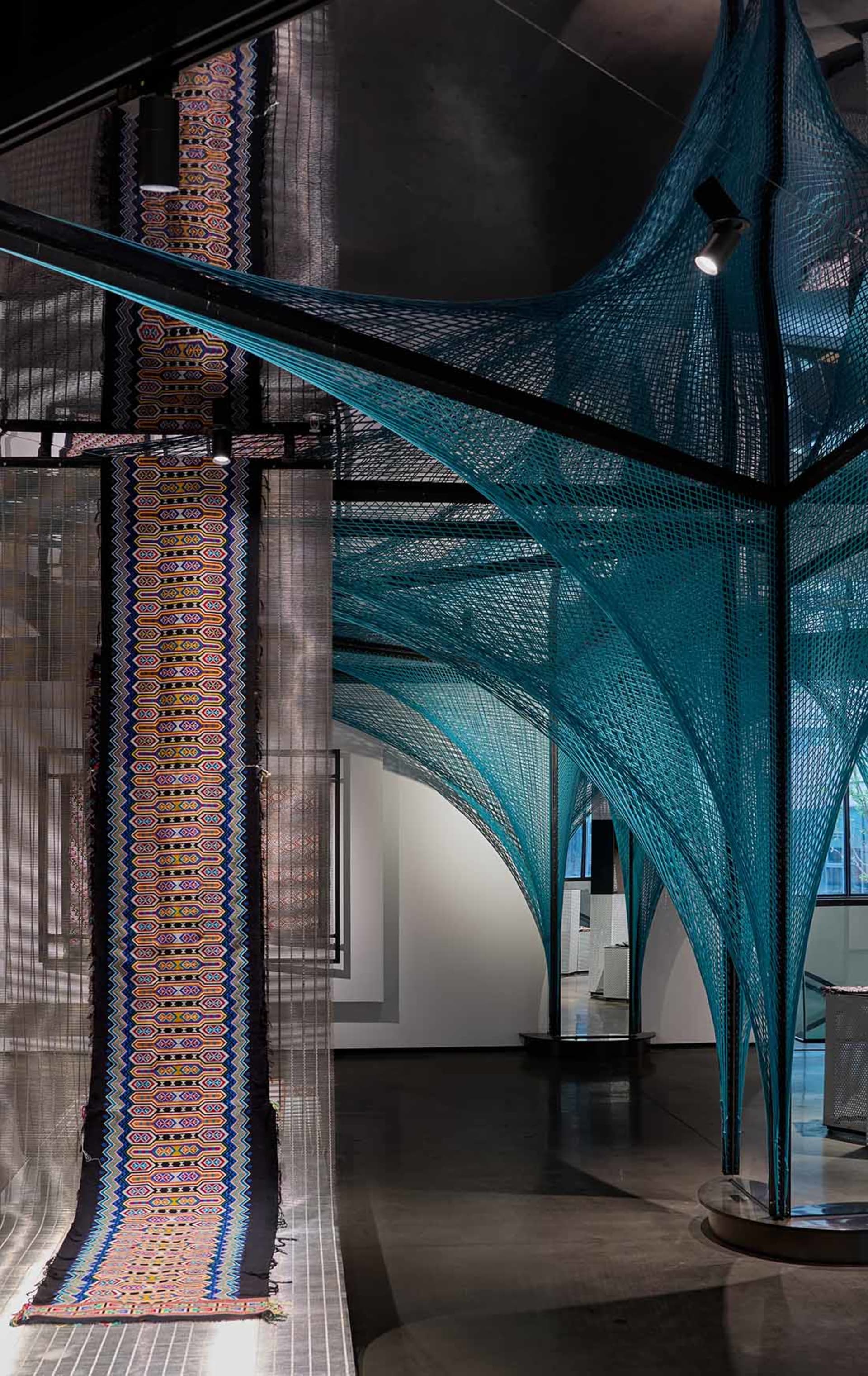 An industrial design installation featuring a teal textile installation
