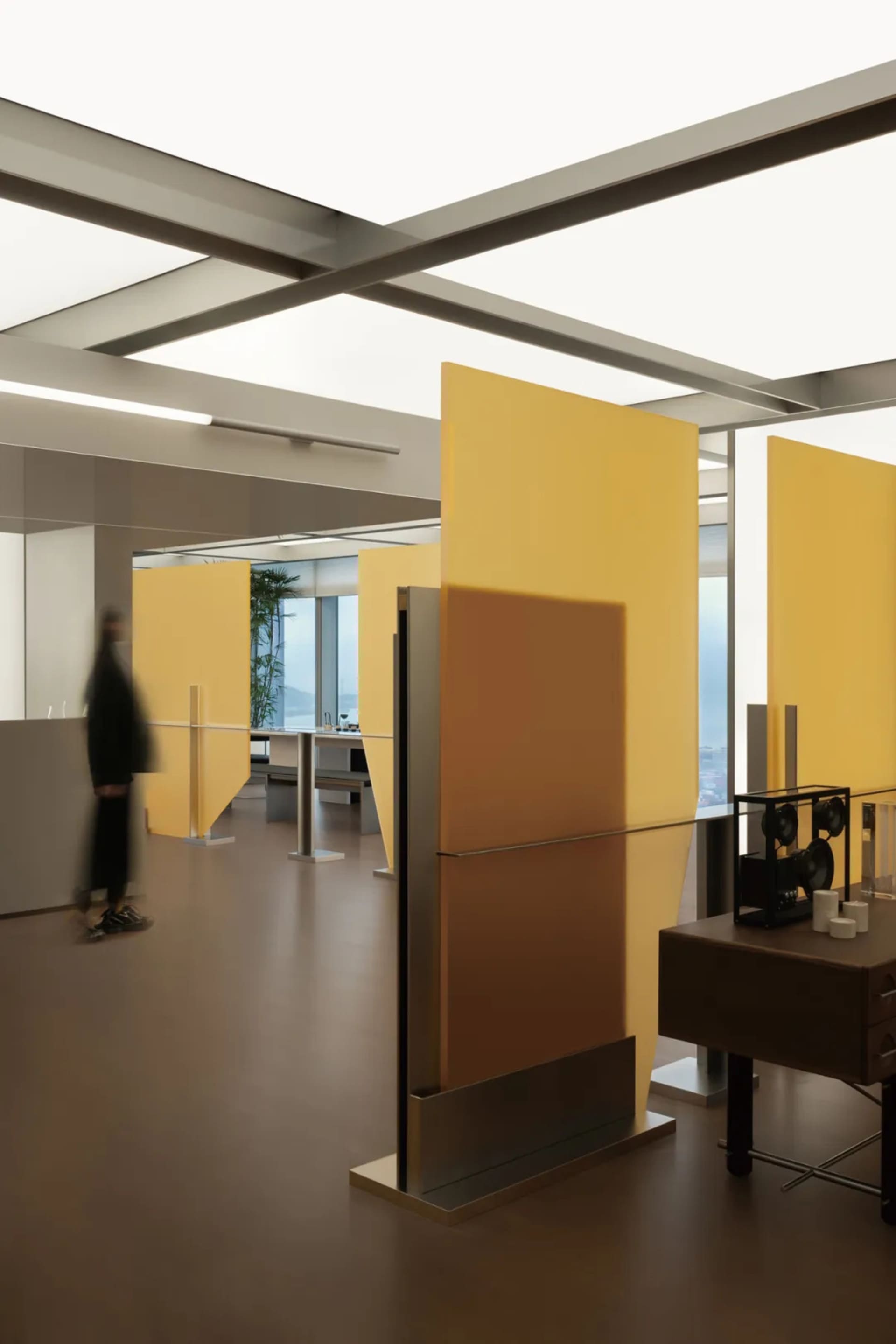 An interior office space with modern design featuring a bold yellow acoustic panel.