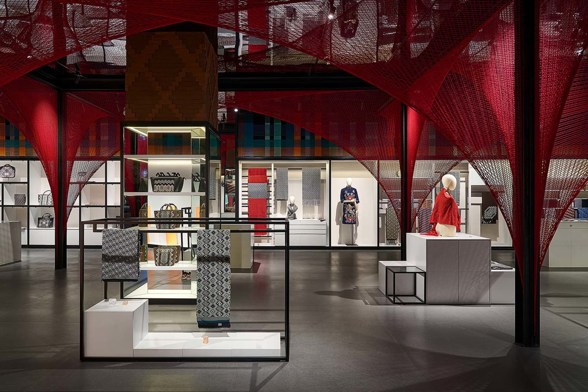 A modern retail space with black, white, and red color scheme and various displays of products.