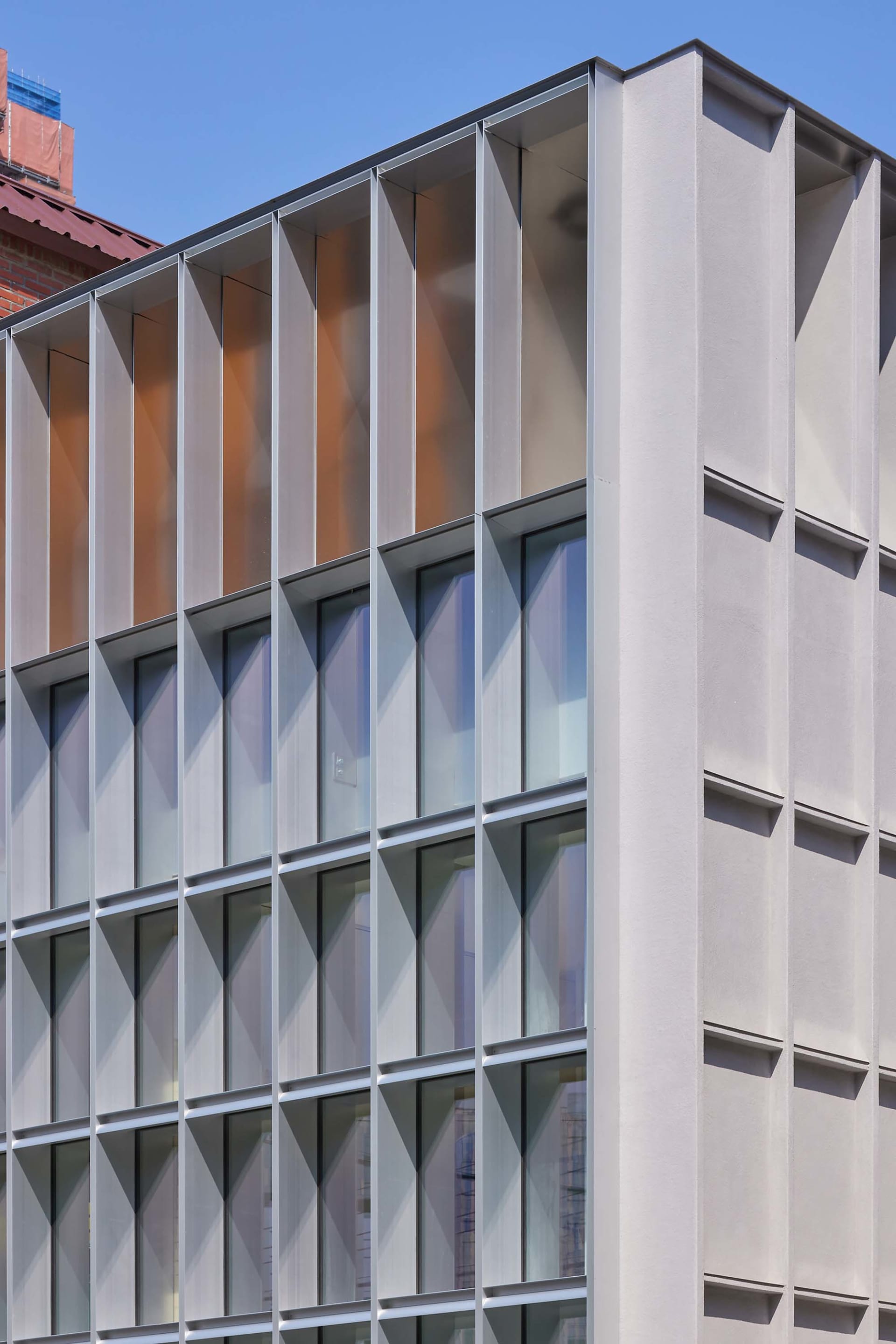 A modern building with a concrete façade and large windows.