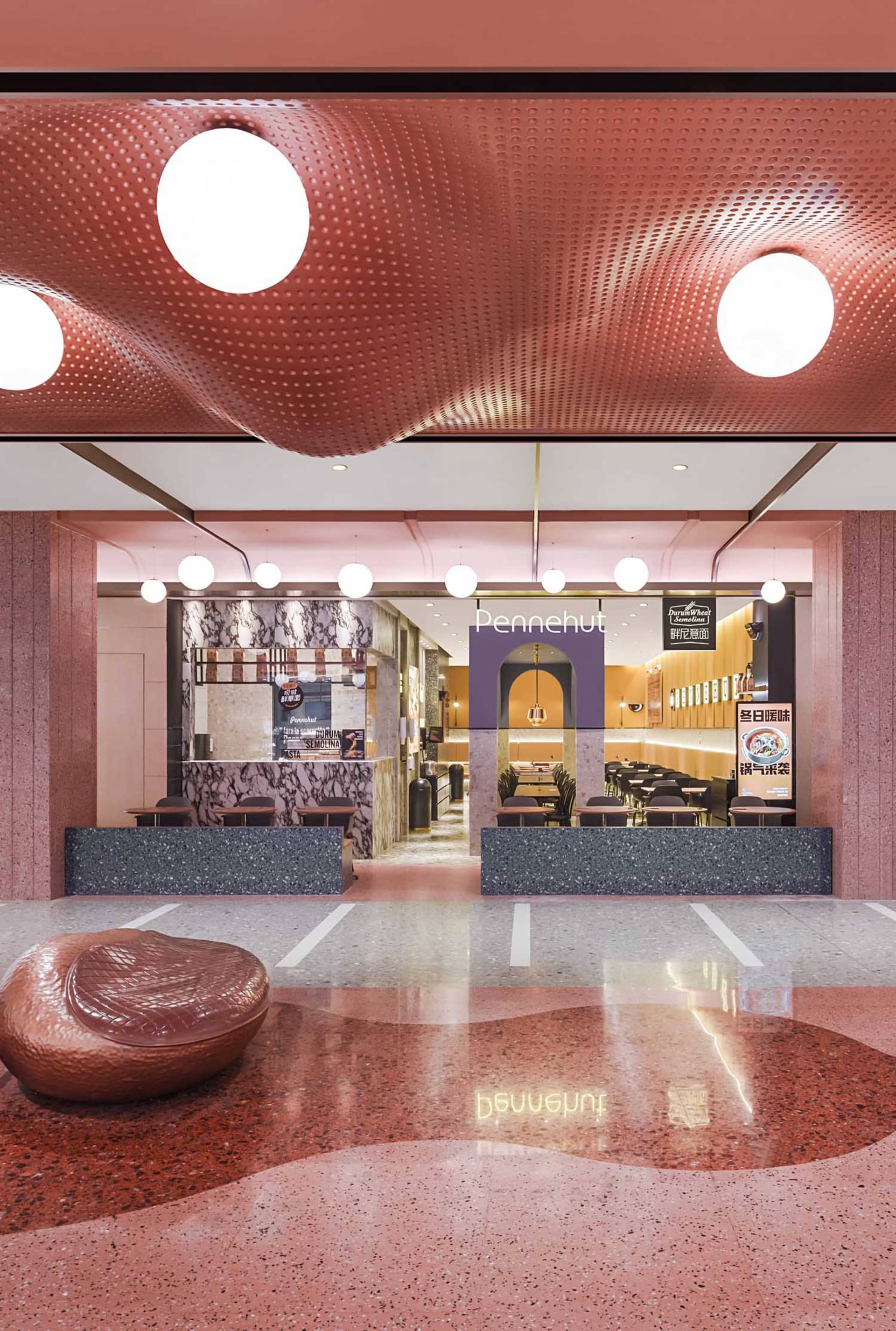 Modern restaurant interior with marble, terrazzo, and metallic accents