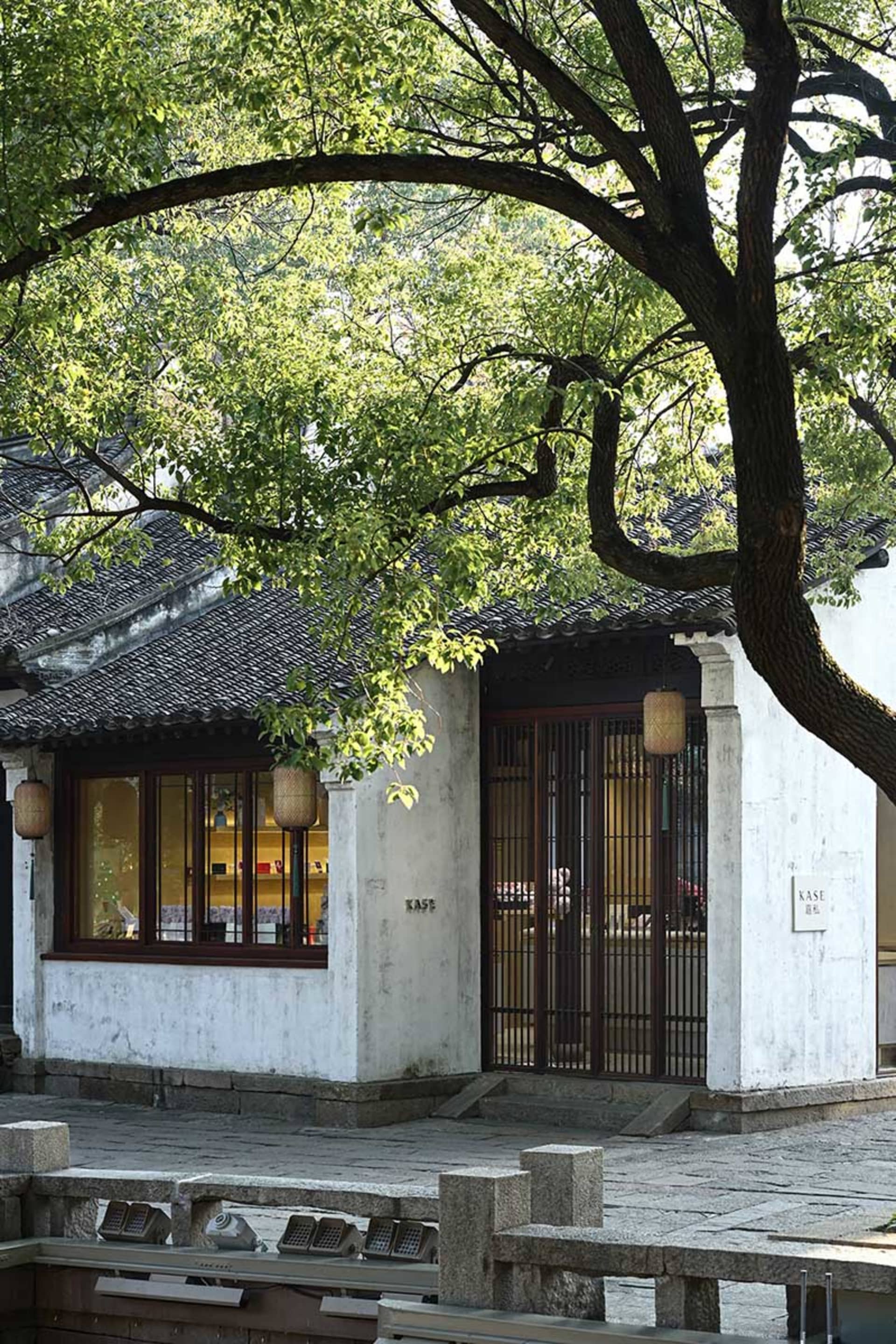 A traditional shopfront with concrete walls and wooden beams.