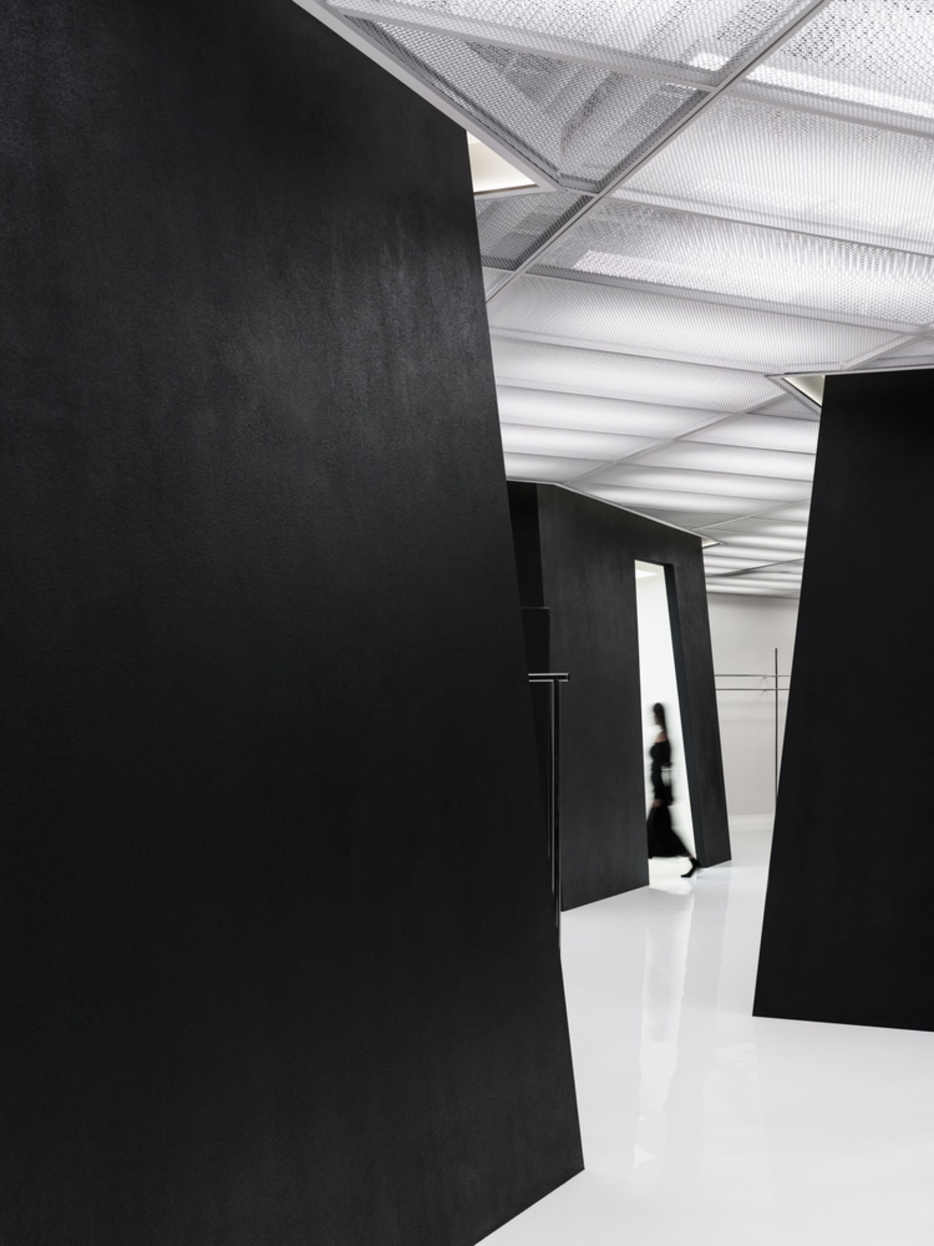 A minimalist black interior space with clean lines and a sleek design.