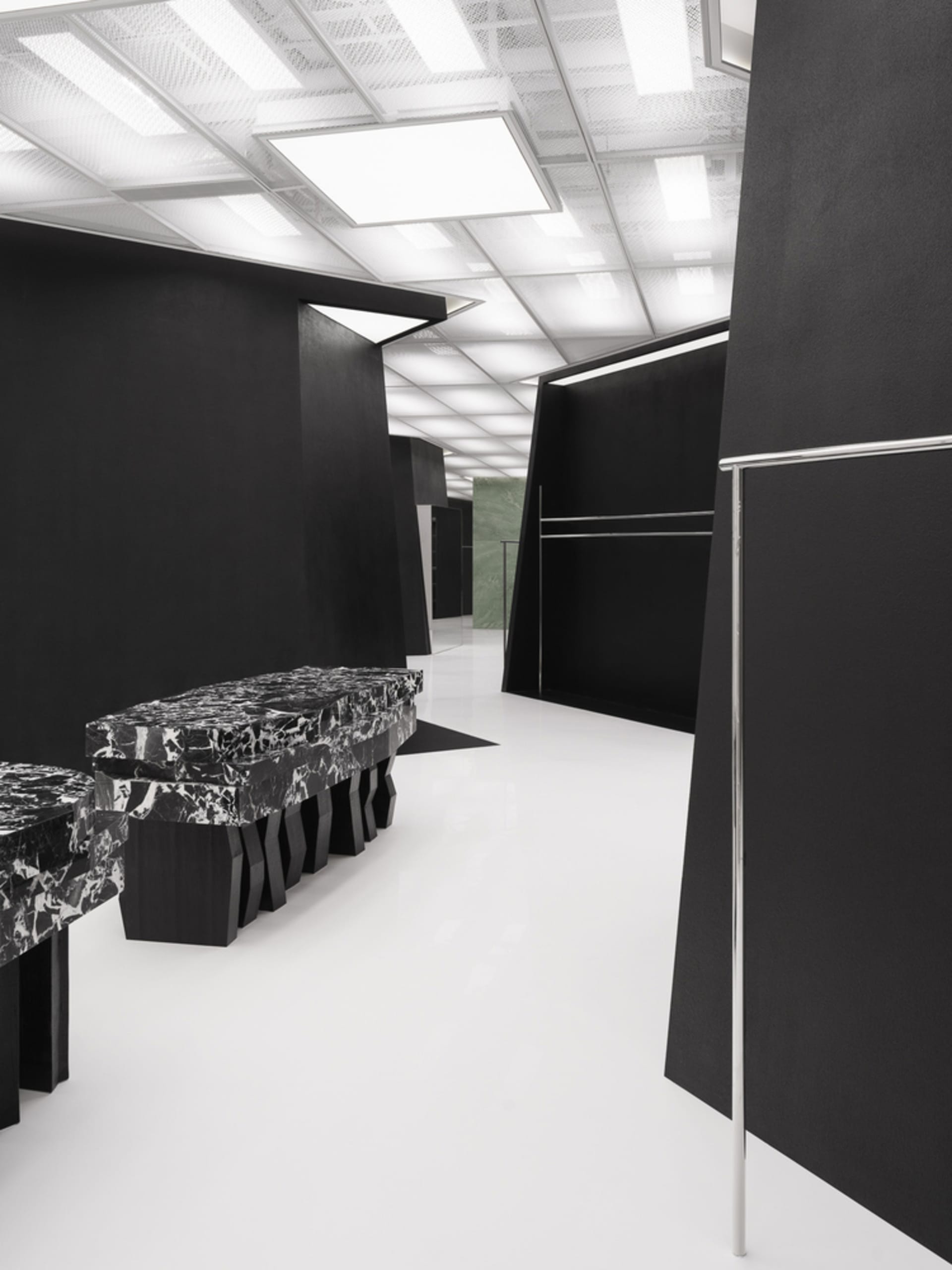 A minimalist retail storefront featuring black marble accents.