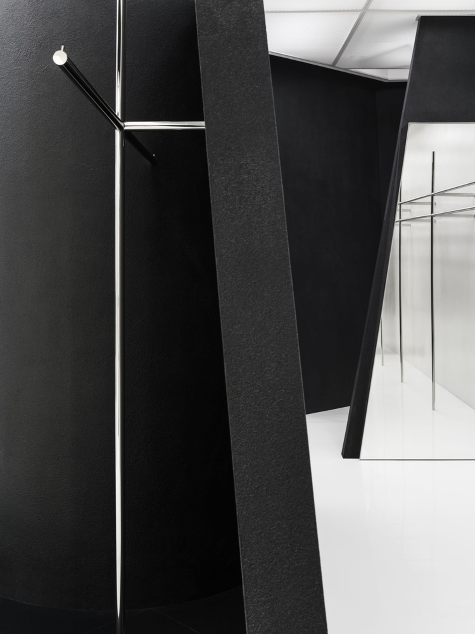 Black metal coat rack in a minimalist interior