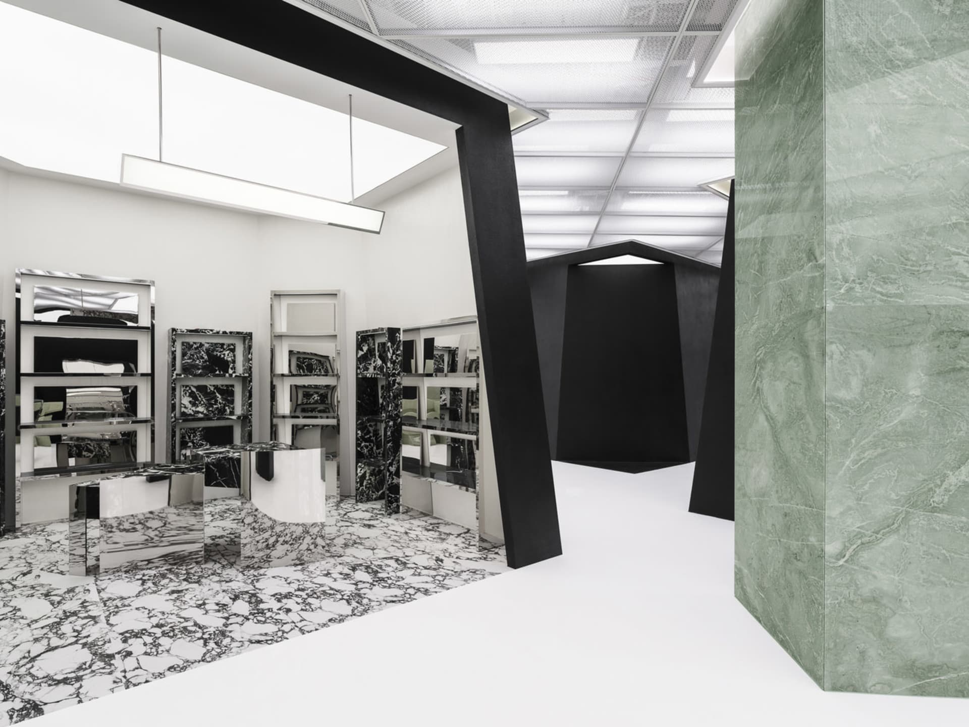 A modern interior design featuring black and white marble and metallic accents.