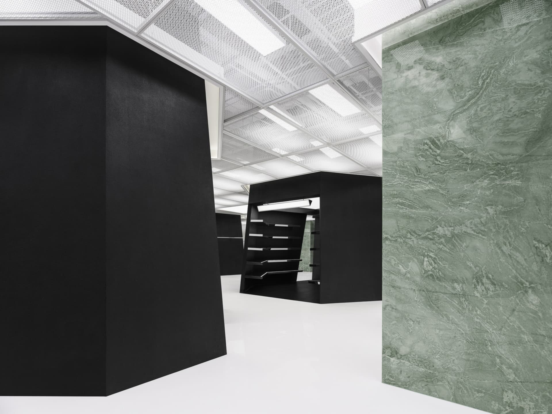 An office space featuring modern design with concrete and glass materials.