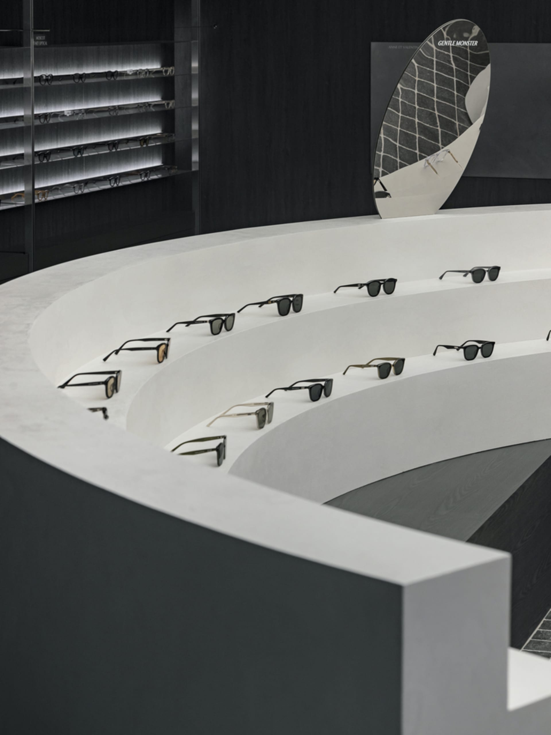 A concrete display featuring multiple pairs of sunglasses in a retail or showroom setting.