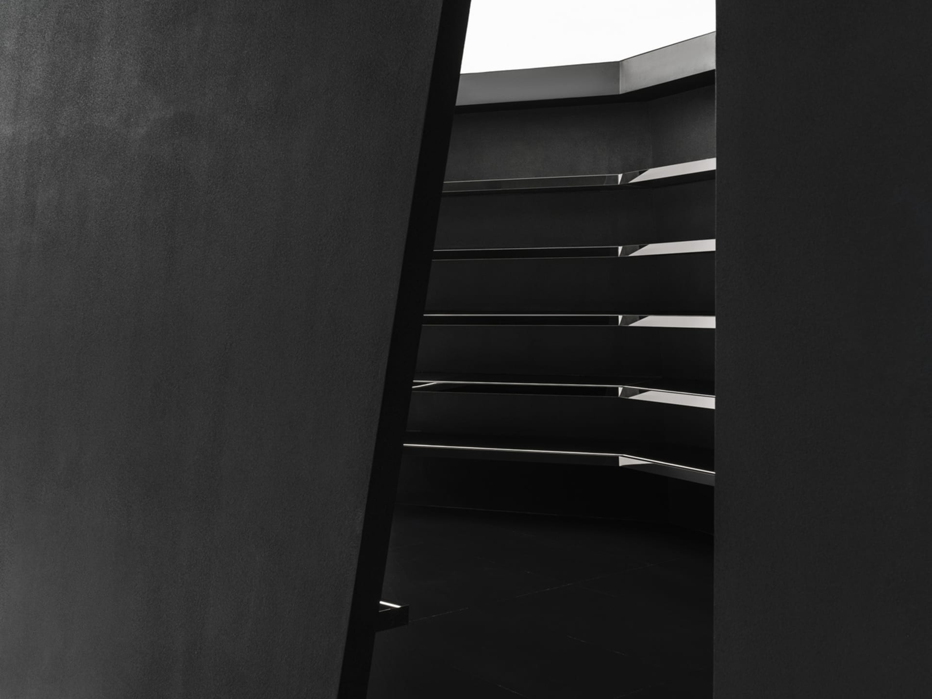 Modern black staircase with metallic elements.