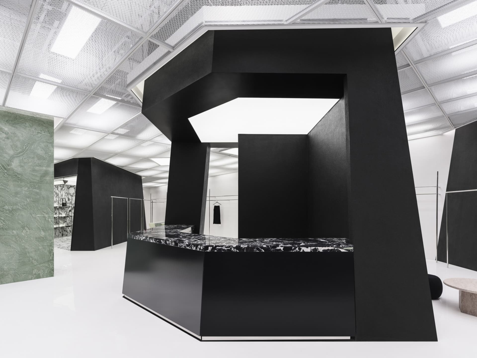 A modern retail storefront featuring black marble surfaces and geometric design elements.