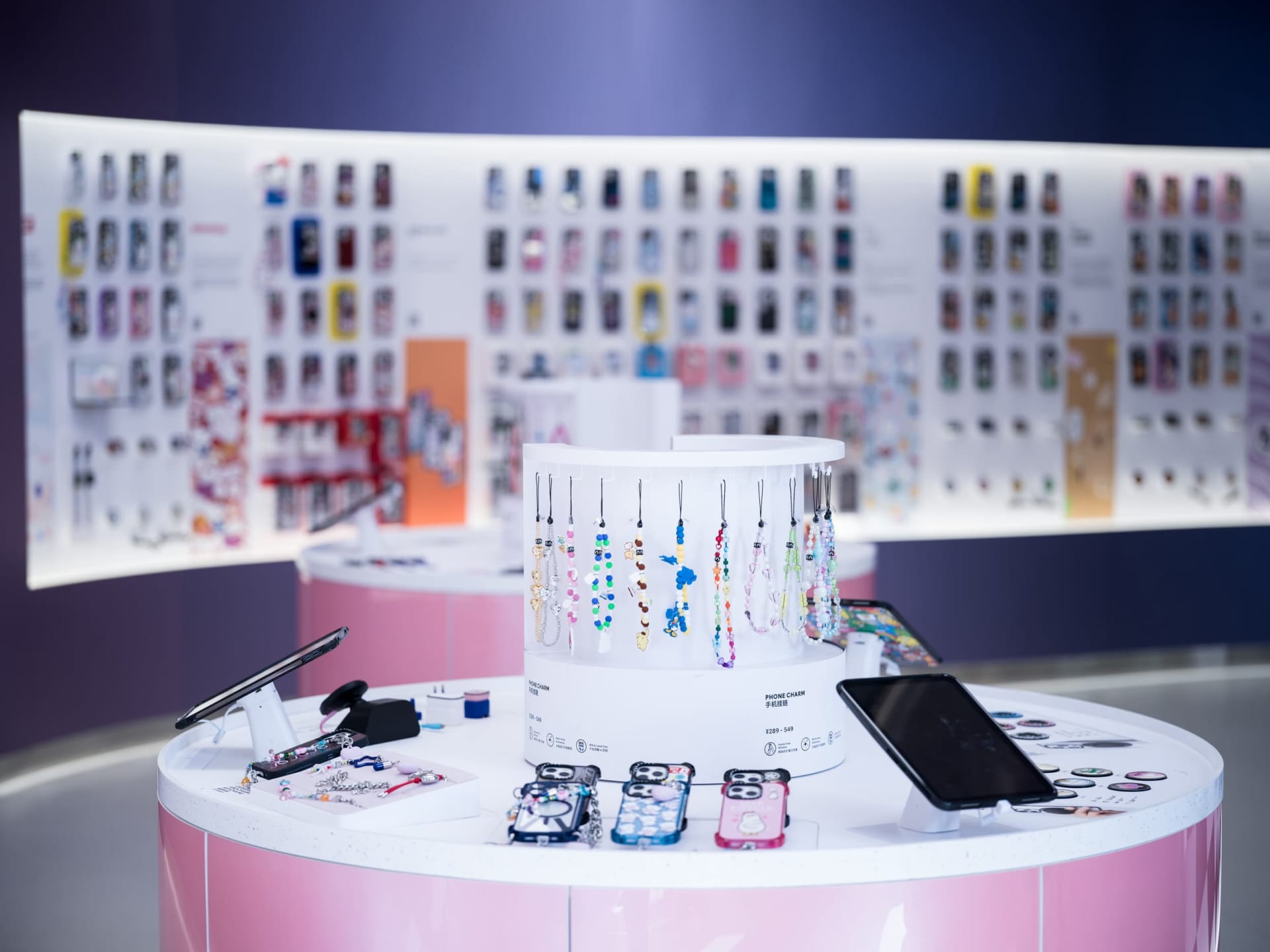 Retail store showcasing various phone accessories, including phone charms and cases.