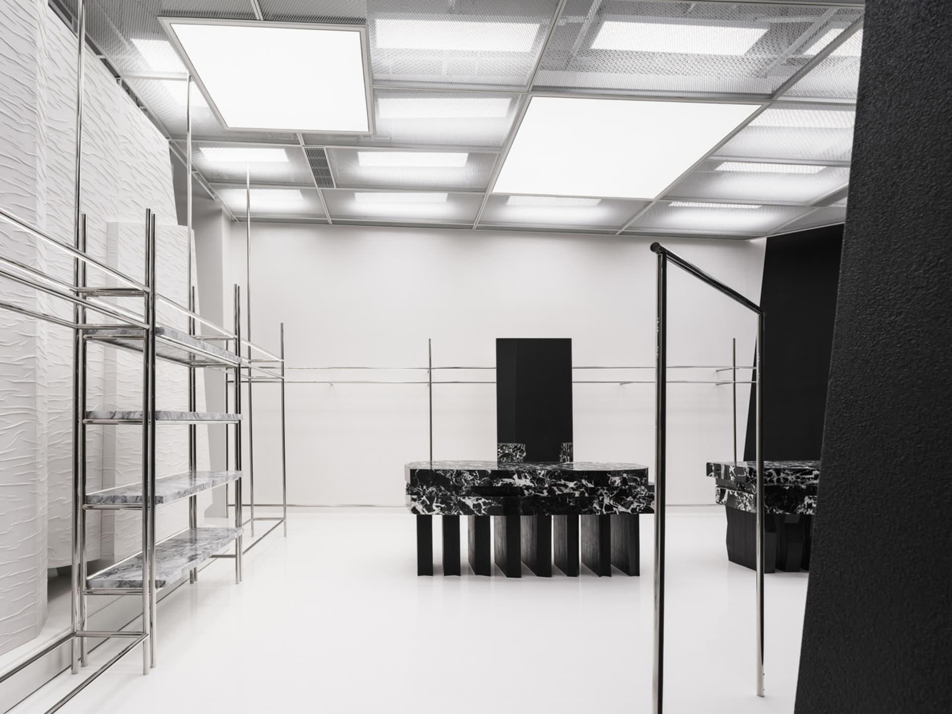 A modern commercial space featuring marble and concrete shelves.