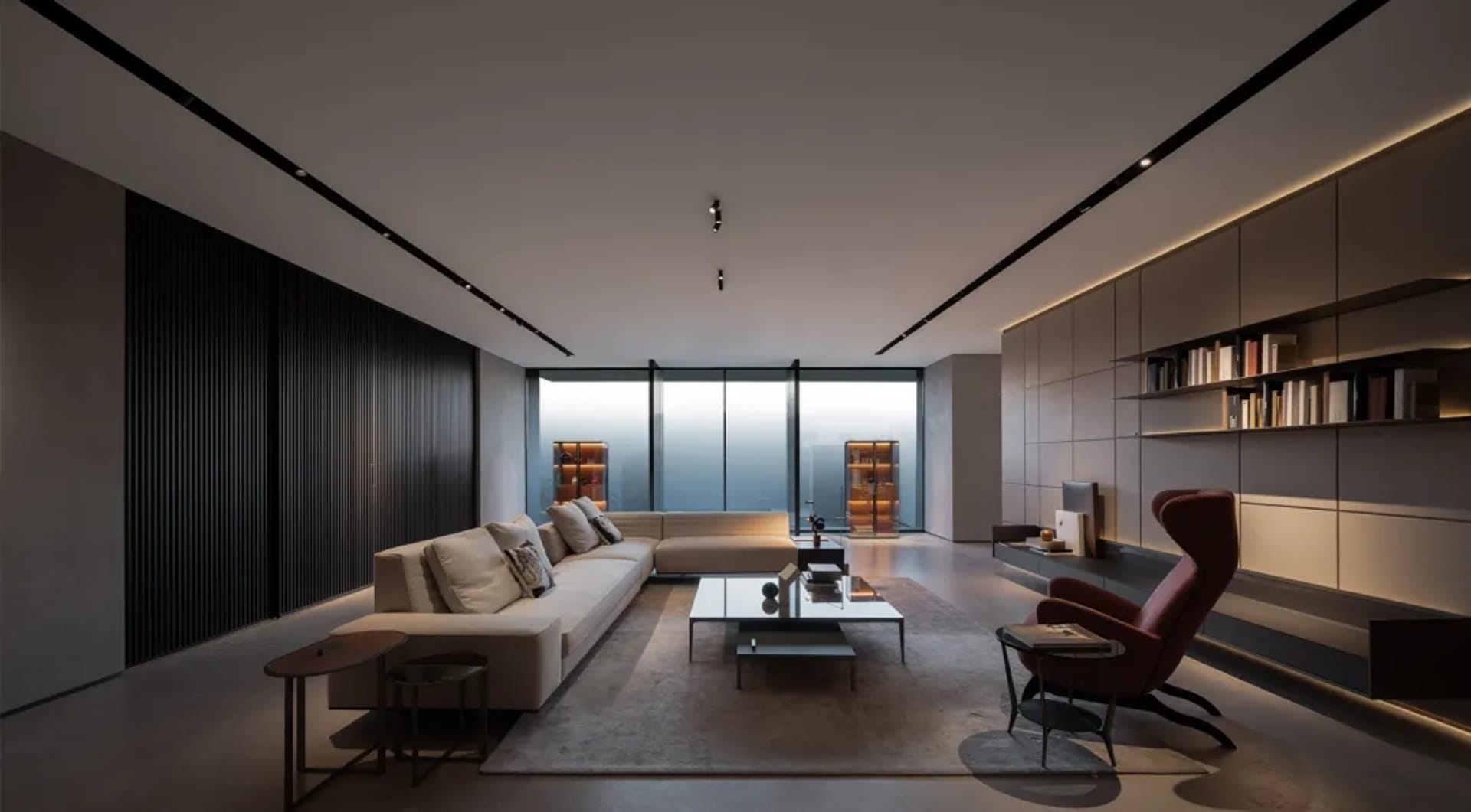 A modern living room with minimalist furniture, warm lighting, and a sleek, contemporary design.