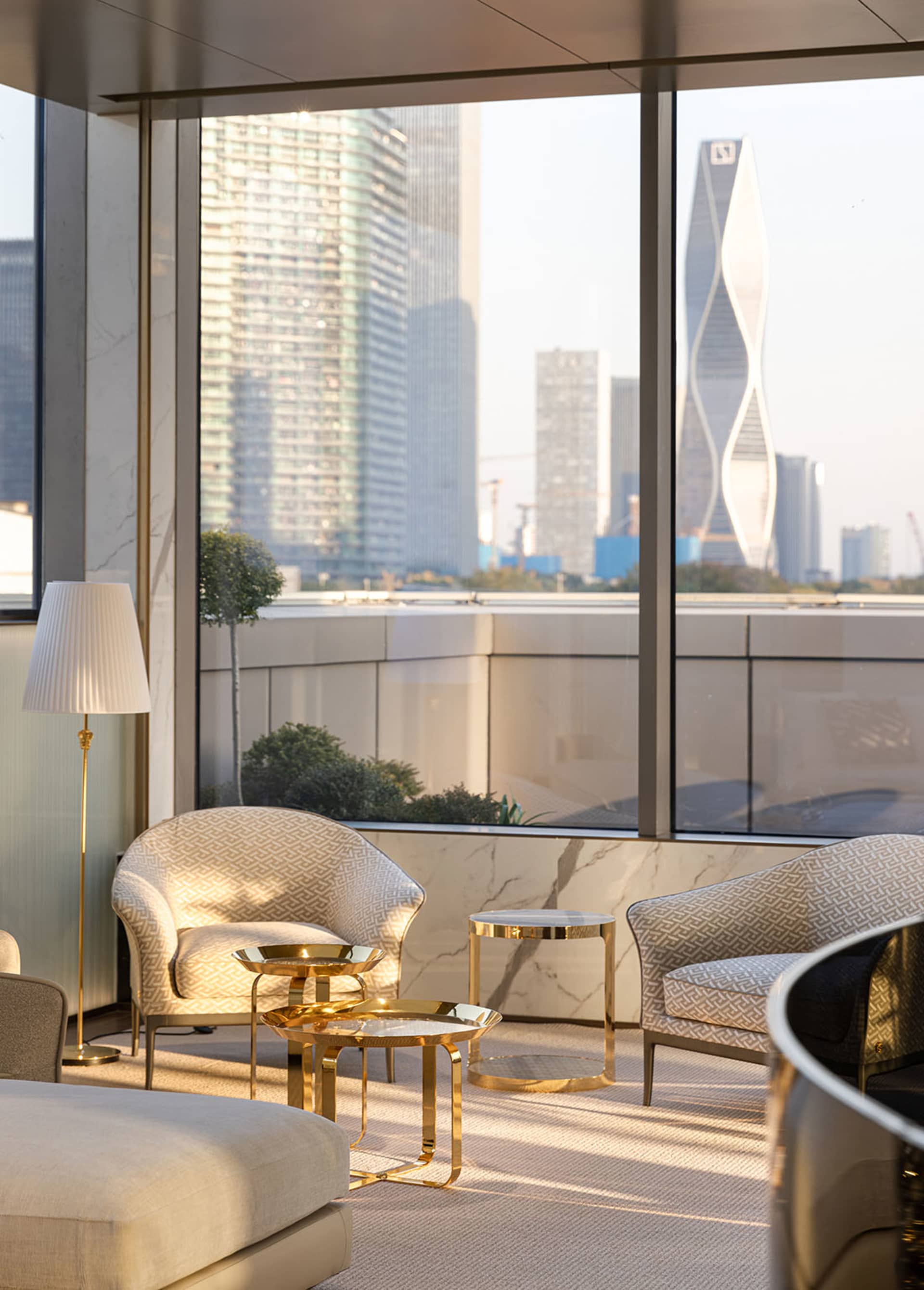 Modern living room featuring marble and golden metal furniture.