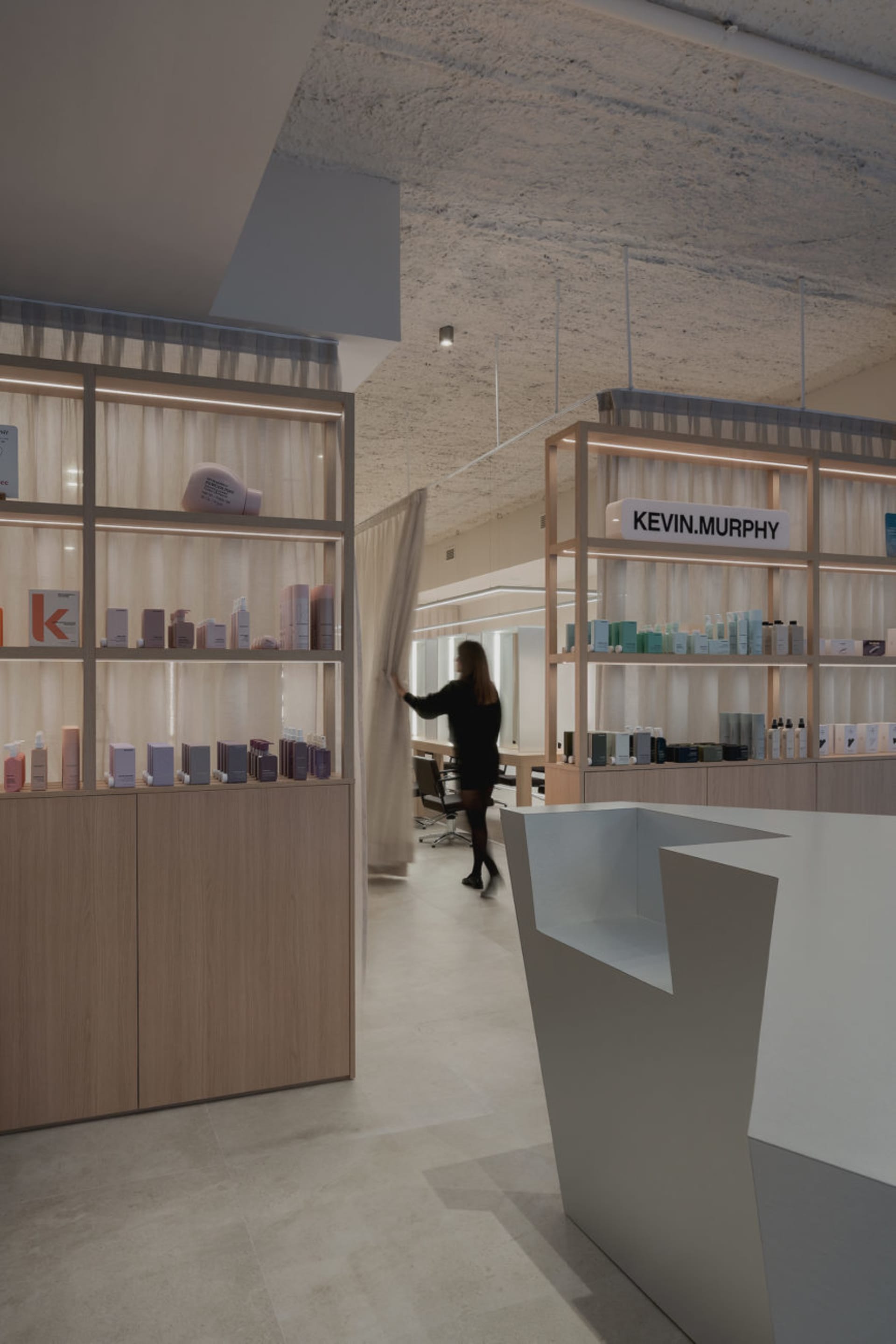 Modern spa interior with wooden shelves and products.