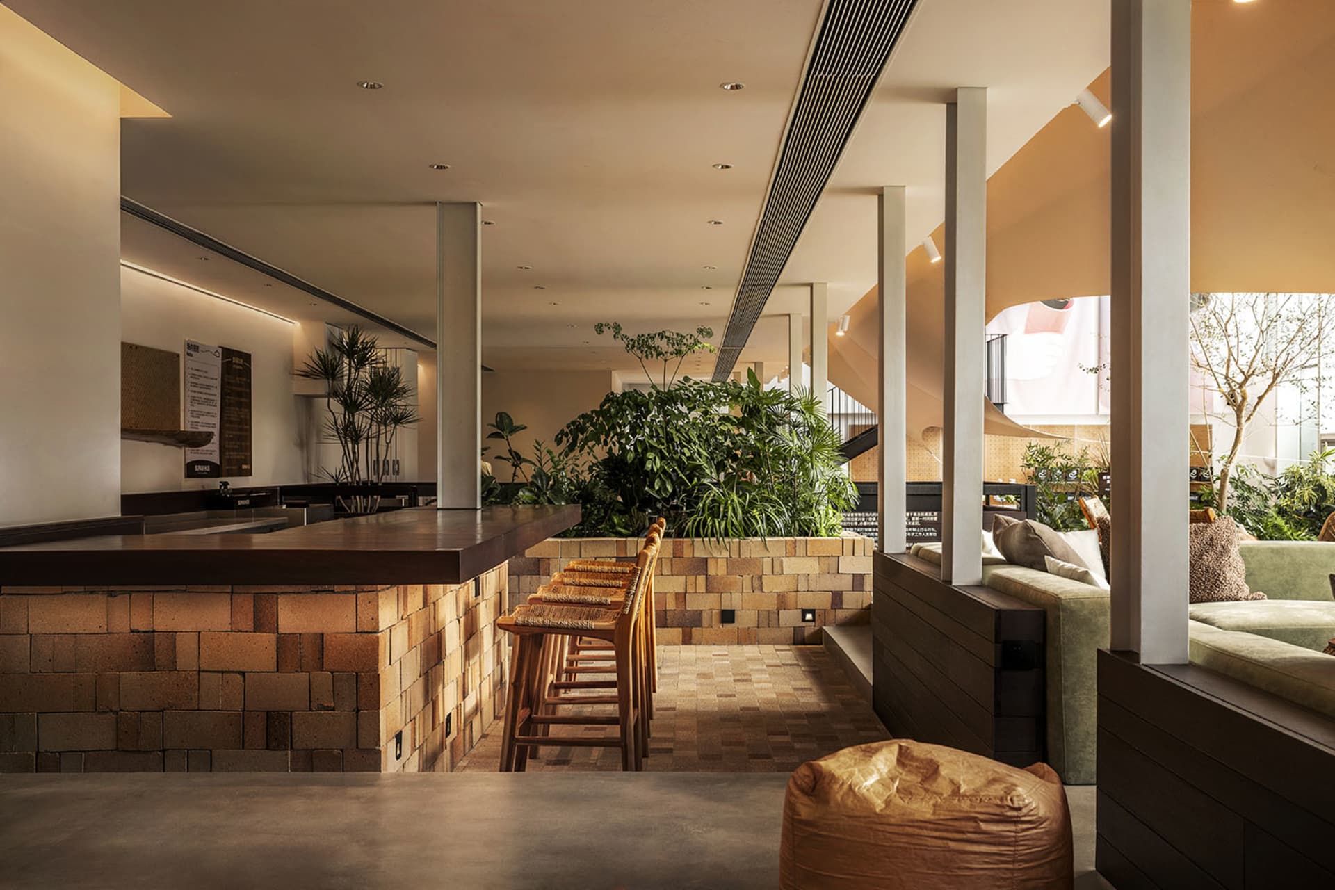 Interior design of a coffee shop featuring brick and concrete materials.