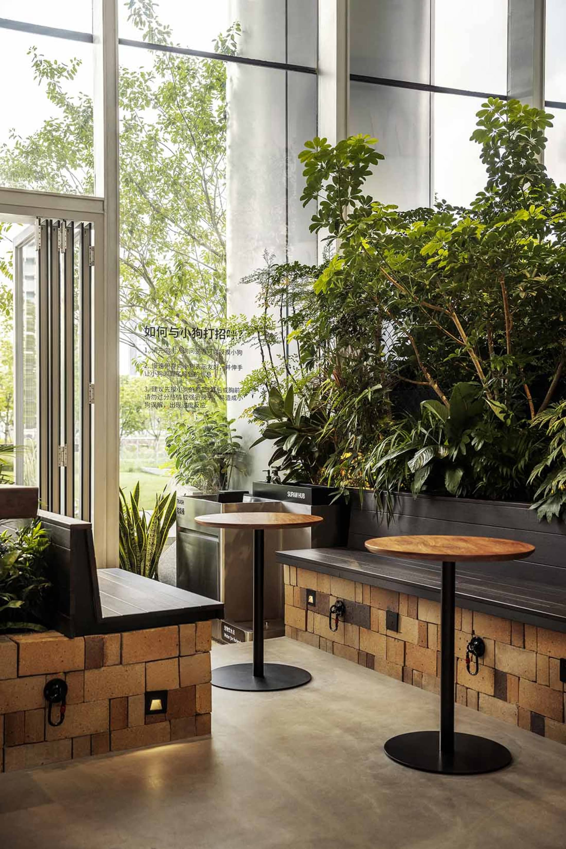A modern coffee shop featuring industrial design elements with brick walls, wooden accents, and metal tables.