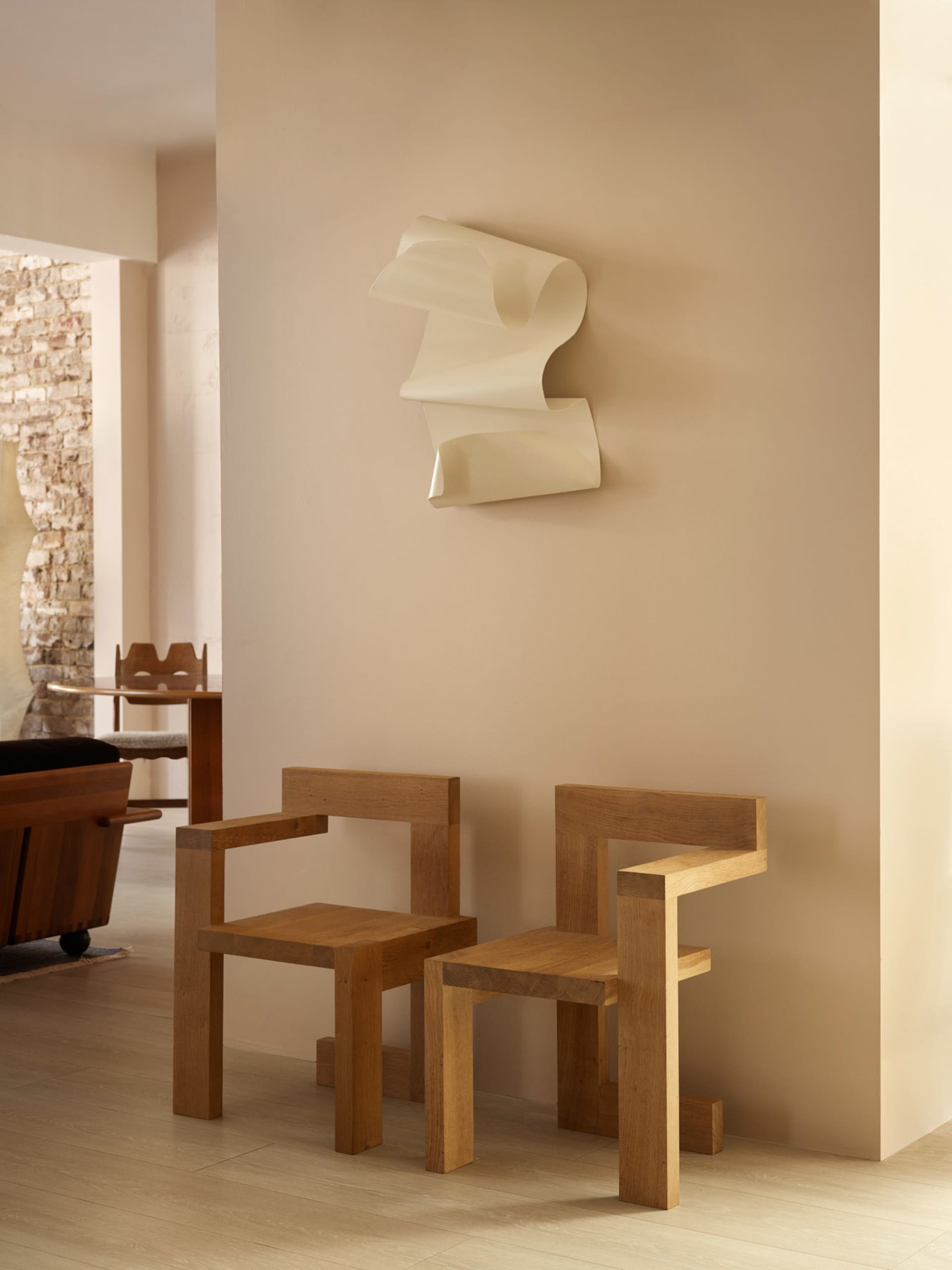 A modern interior design featuring wooden furniture with unique geometric shapes.