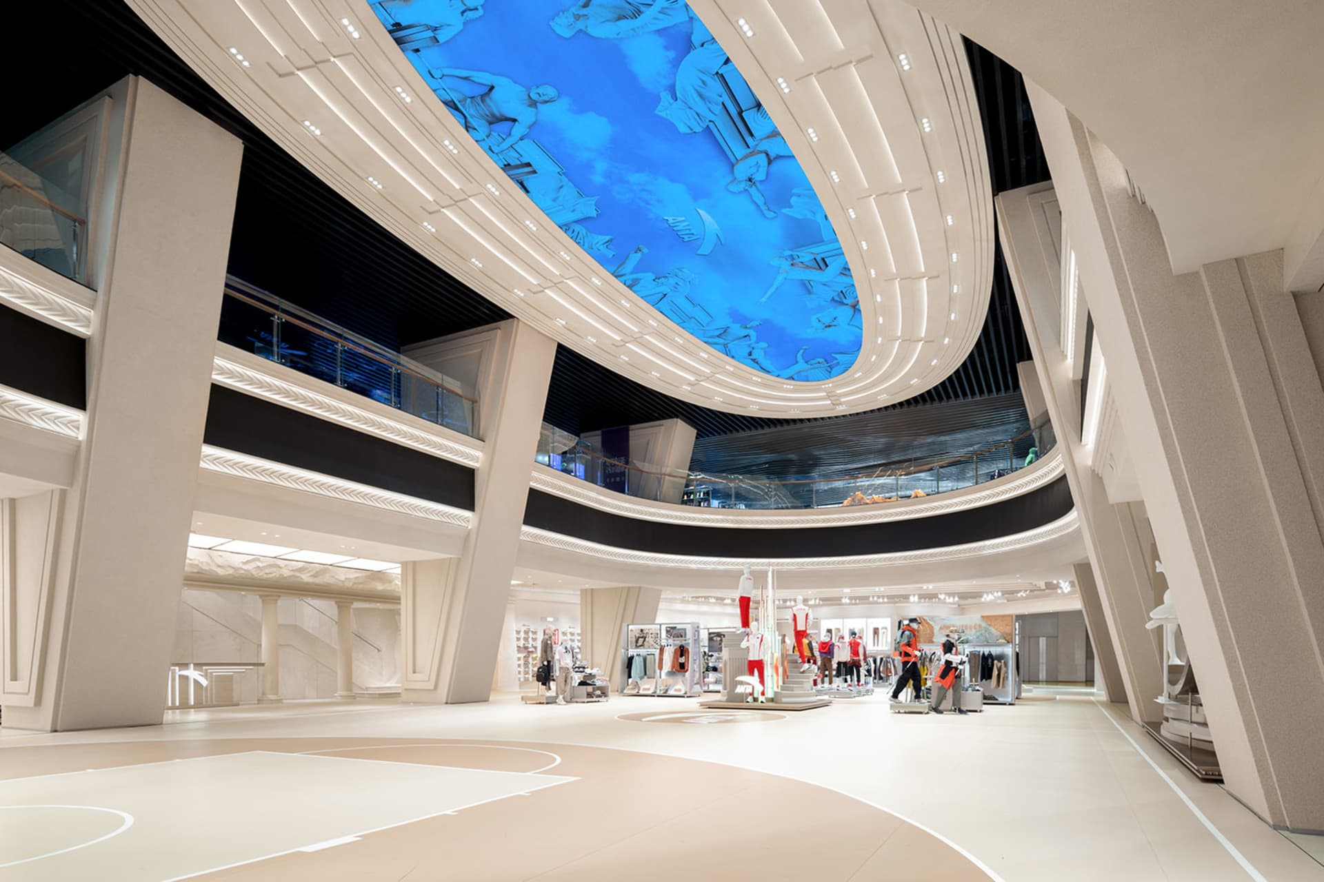 A modern retail space with a concrete floor, featuring minimalist design elements and a large, curved ceiling with blue light