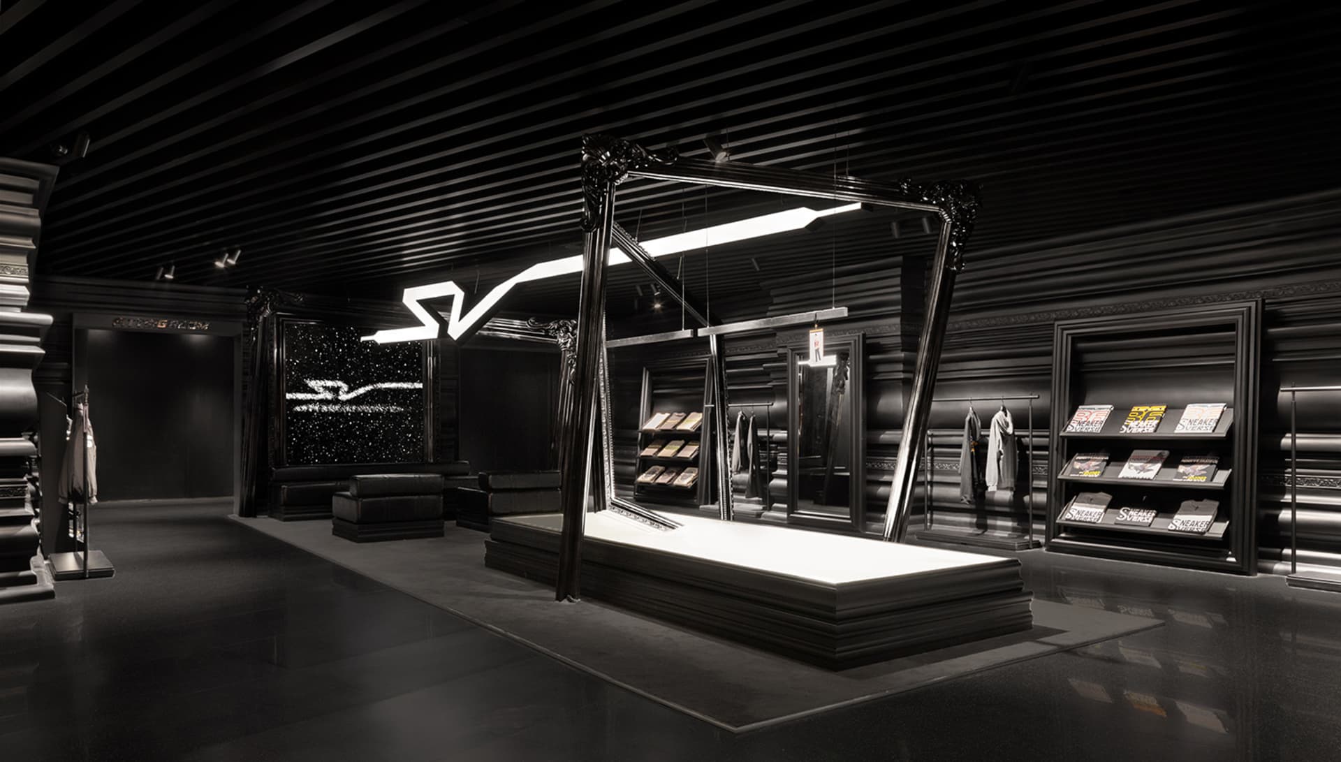 A minimalist retail space with a black metallic interior design and abstract lighting installation.