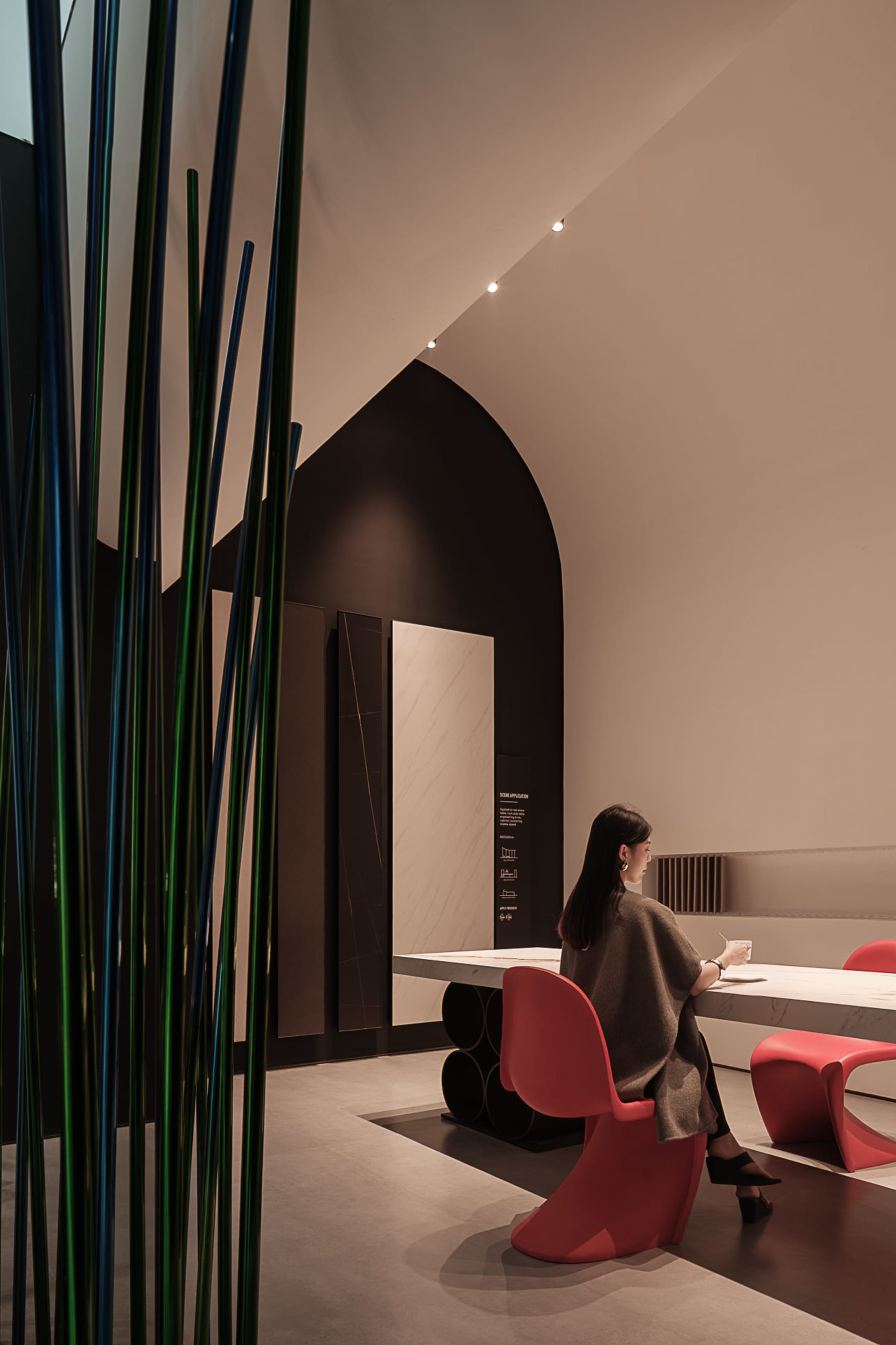 A modern restaurant with metallic decor and marble countertops.