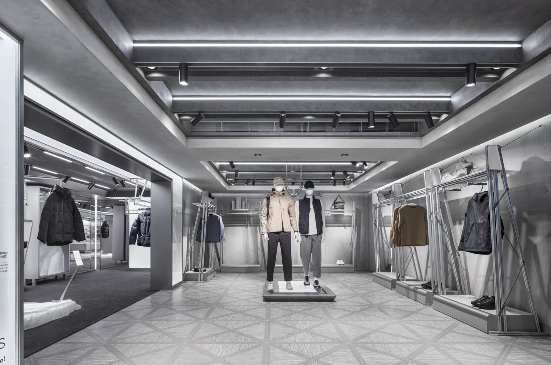 A modern retail display showcasing clothing items in a metallic setting.
