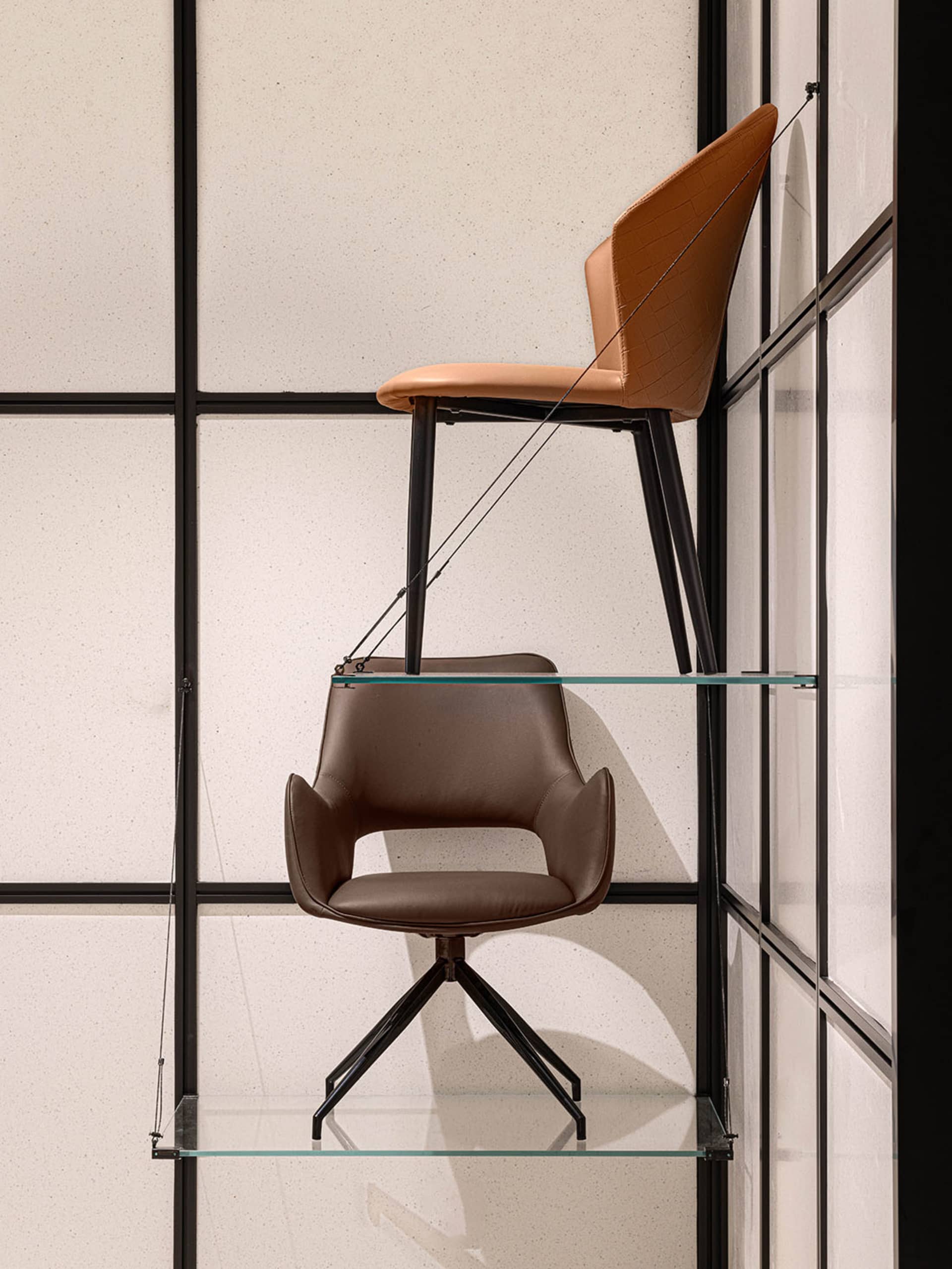 Industrial-style furniture design with brown leather upholstery and metal legs.