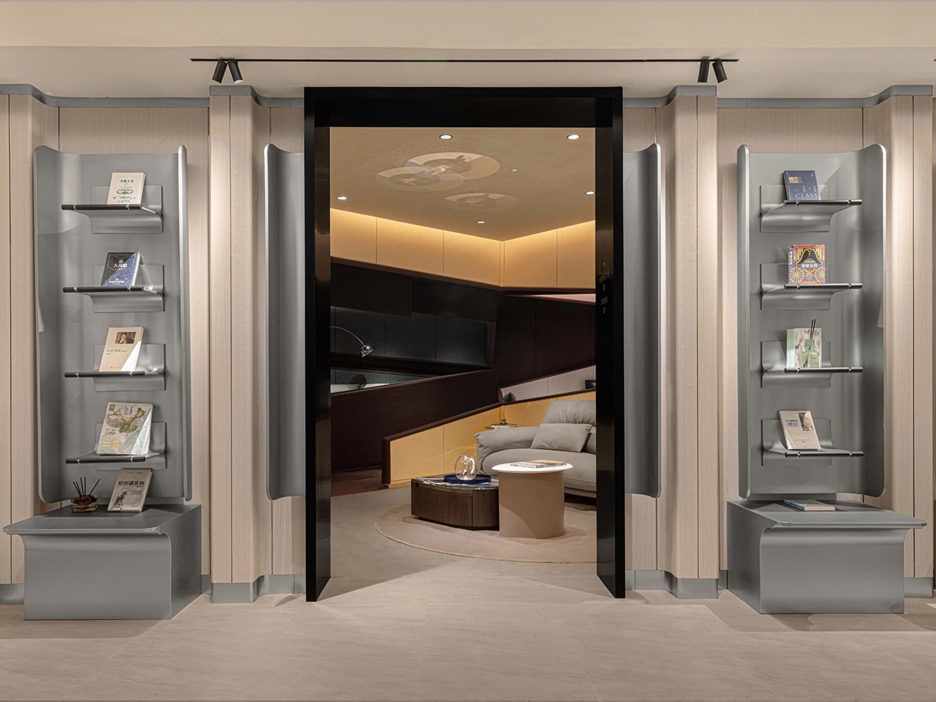 A modern office lounge features metal bookshelves and a comfortable seating area.