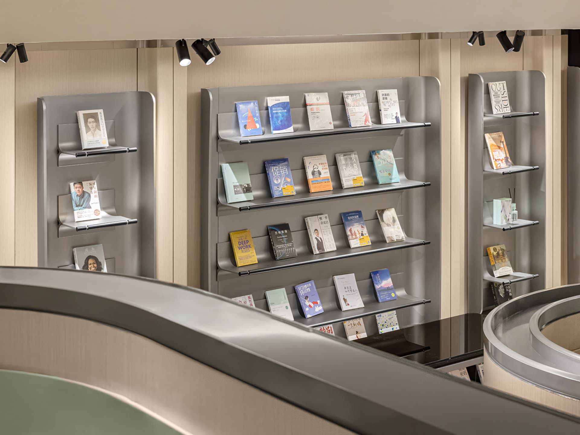 A modern metal bookshelf displaying various books.