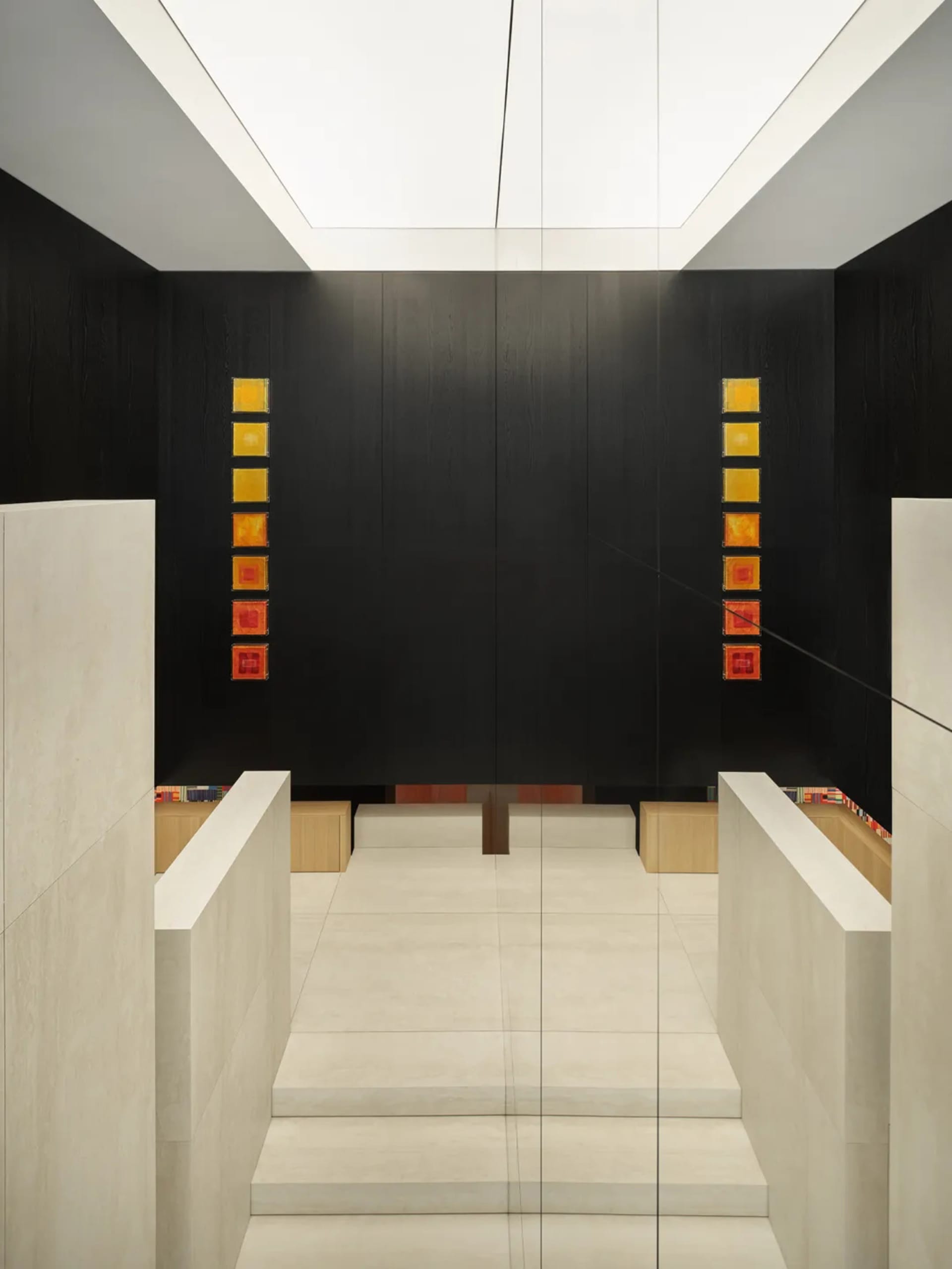 Modern retail storefront featuring a minimalist design with concrete and glass materials.