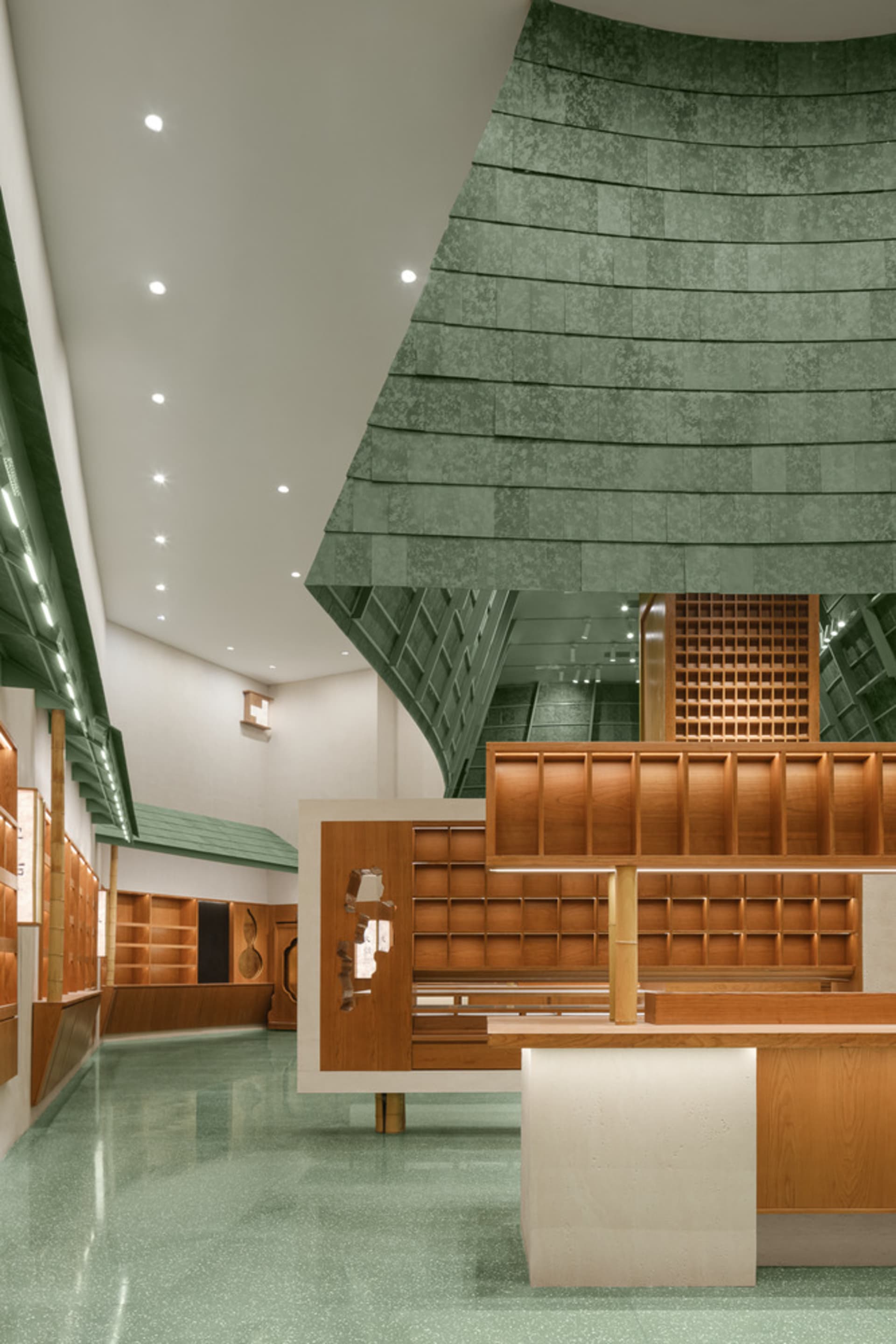 A modern bookstore with wooden features and a green, textured floor.
