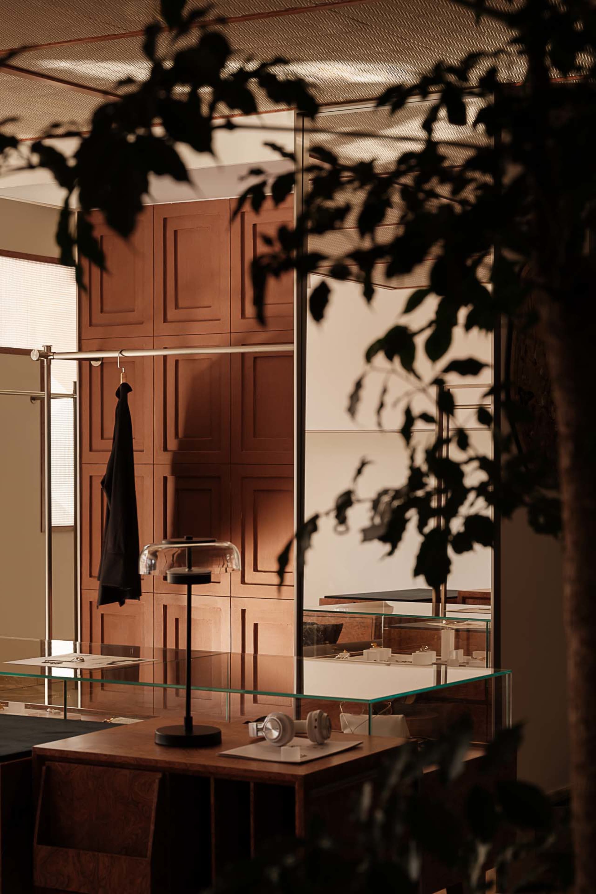 Modern retail storefront featuring wooden cabinets, glass displays, and metal accents.