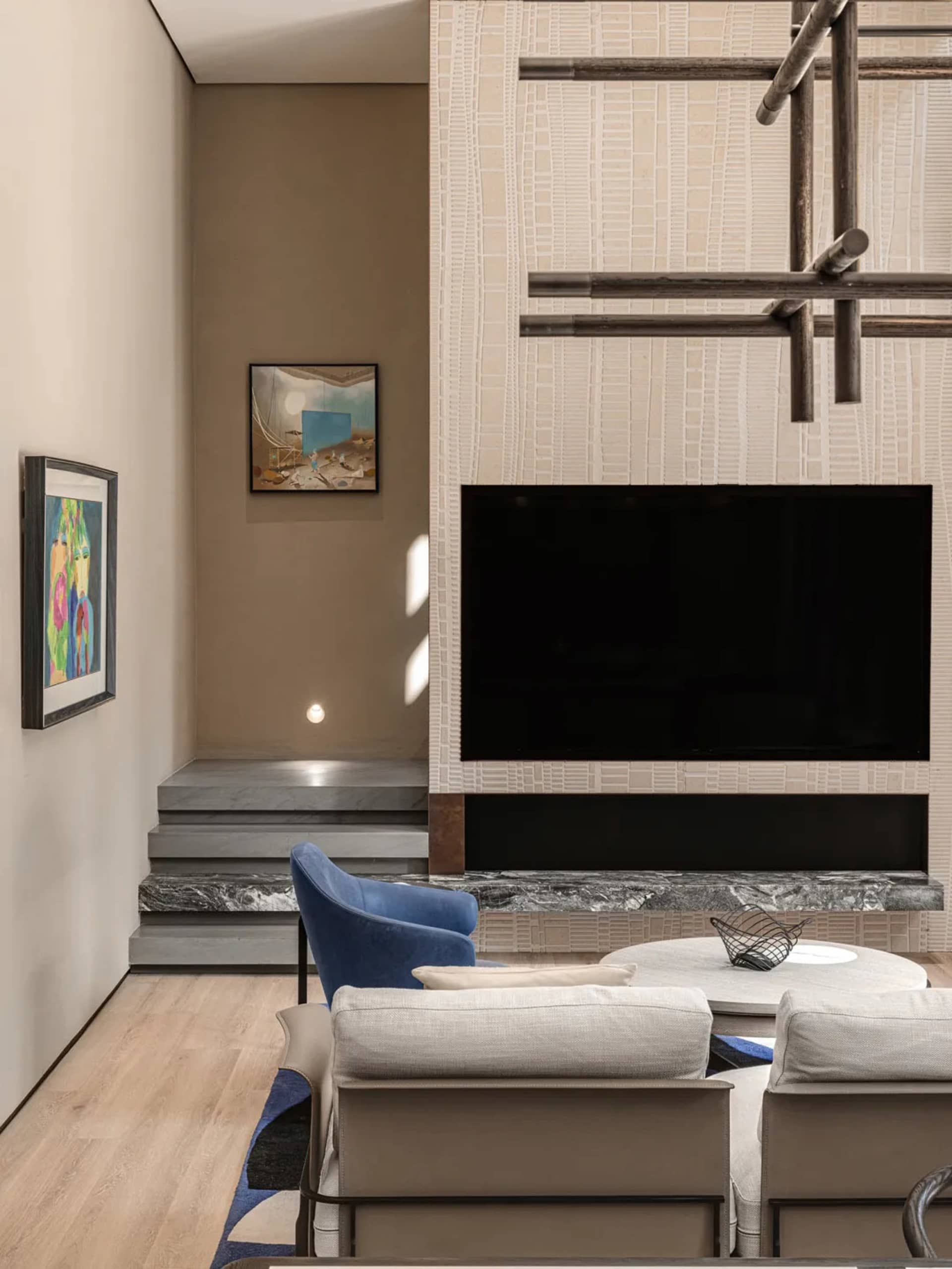 A minimalist living room featuring stone and wood elements