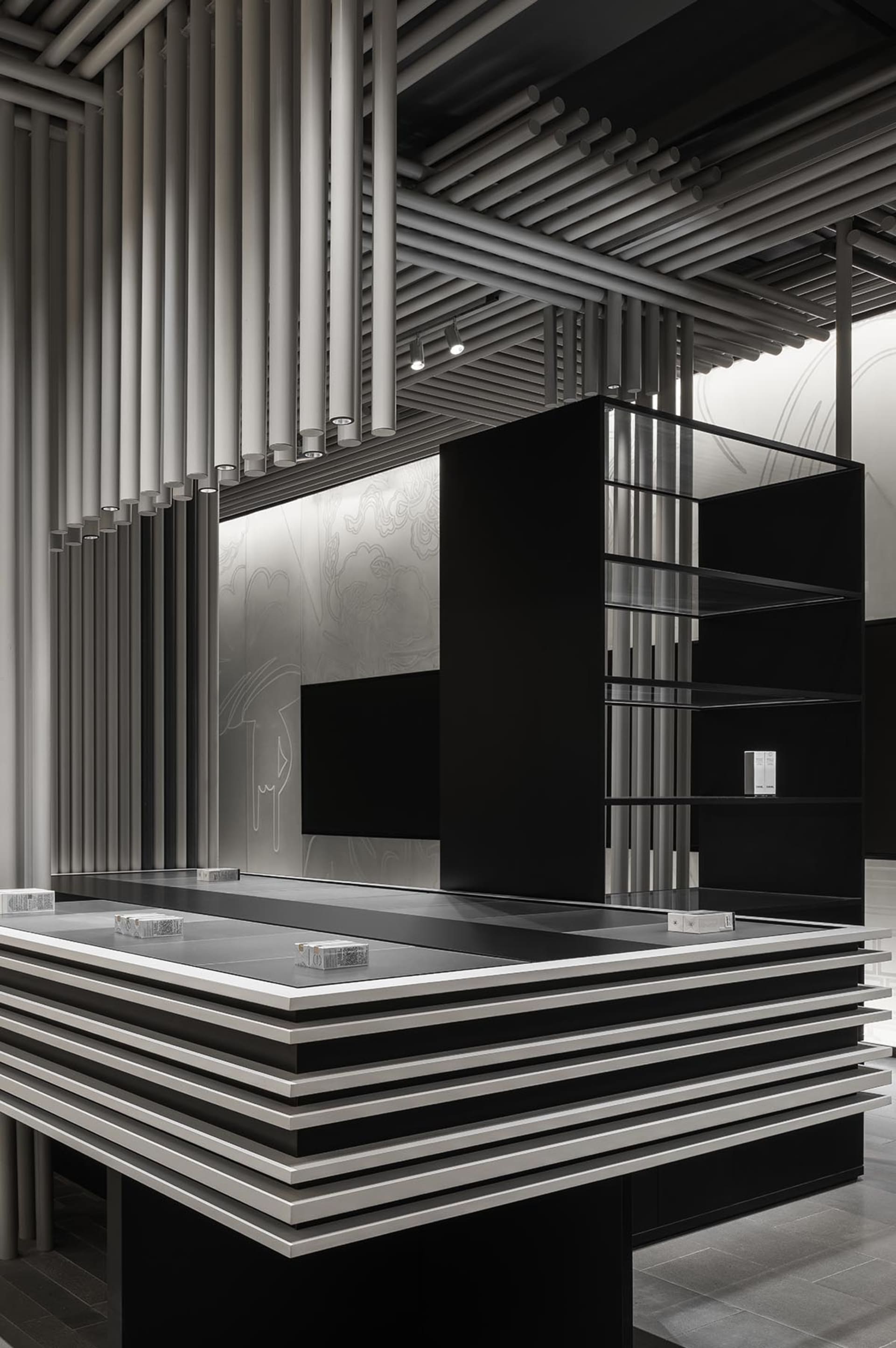 A modern shopping center counter made of metal and glass.