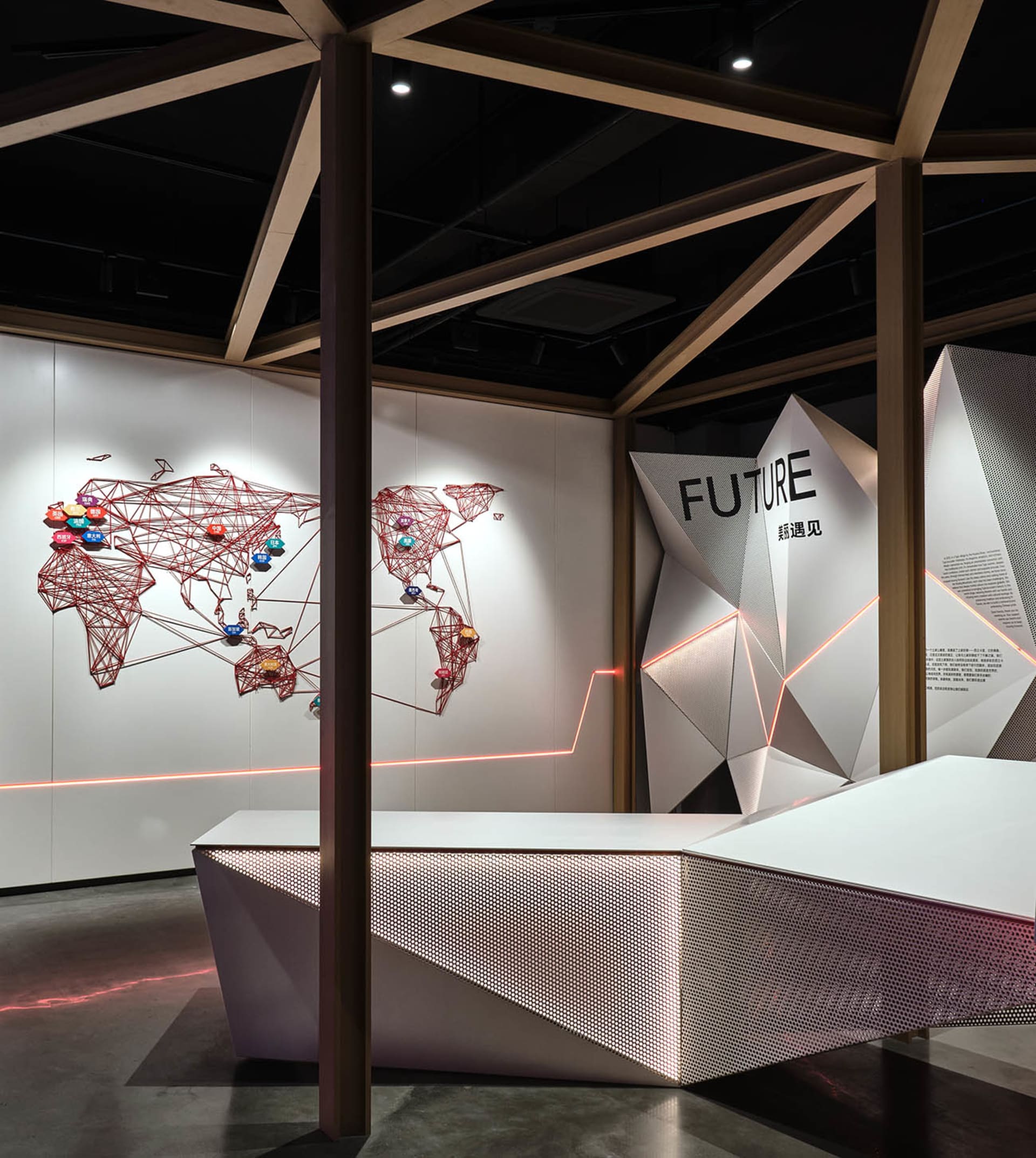 A modern exhibition space featuring geometric shapes and metallic elements.