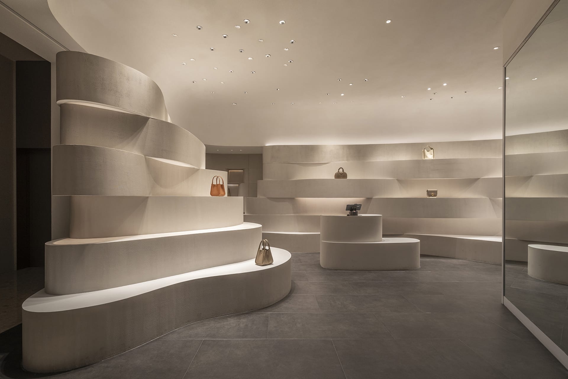Modern retail store interior featuring minimalist design with concrete elements