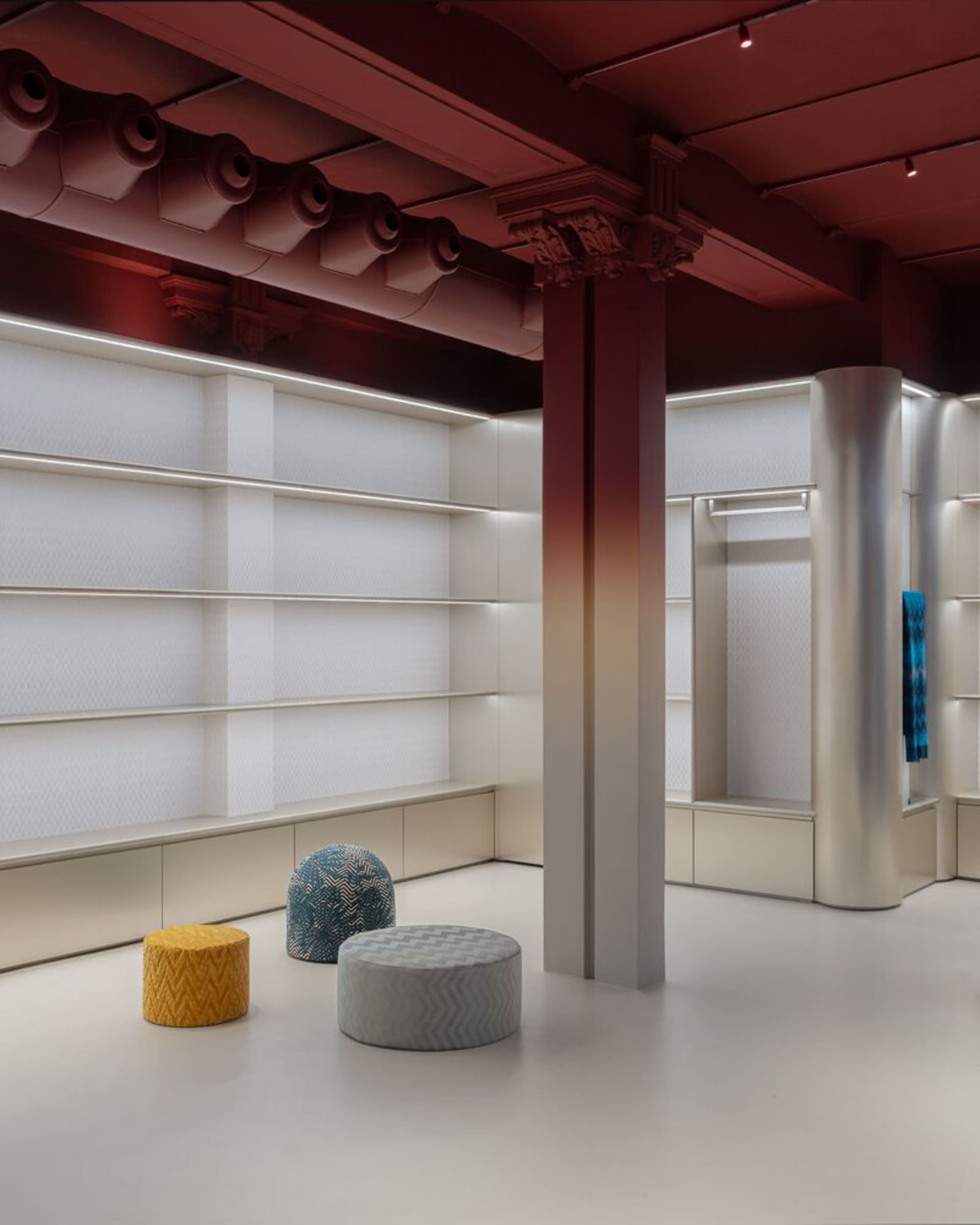 A modern interior design featuring colorful poufs in fabric textiles.