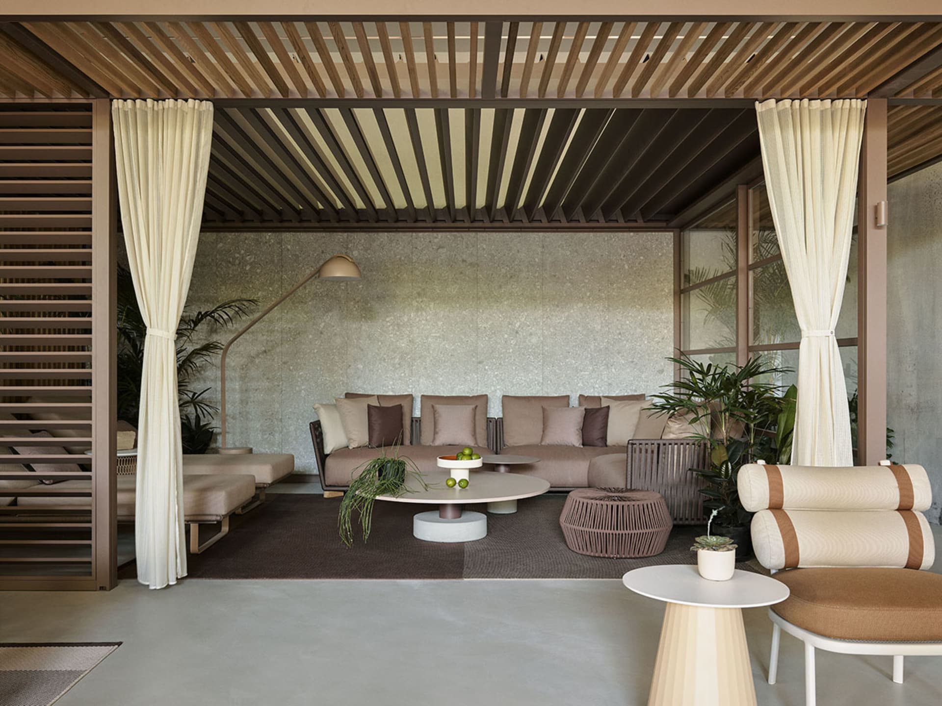 Modern lounge area with concrete furniture and skylight ceiling