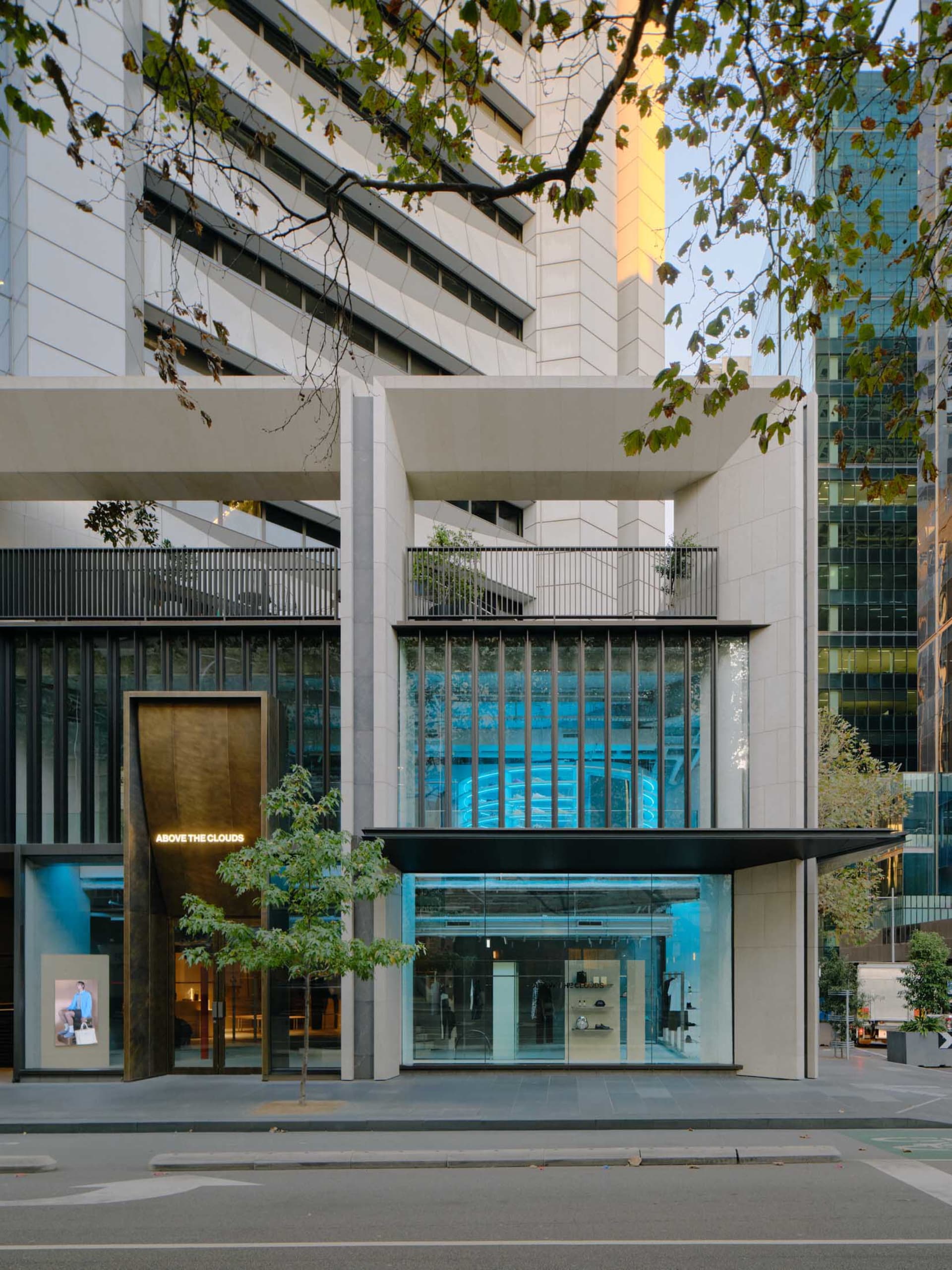 Modern retail storefront featuring glass and concrete materials.