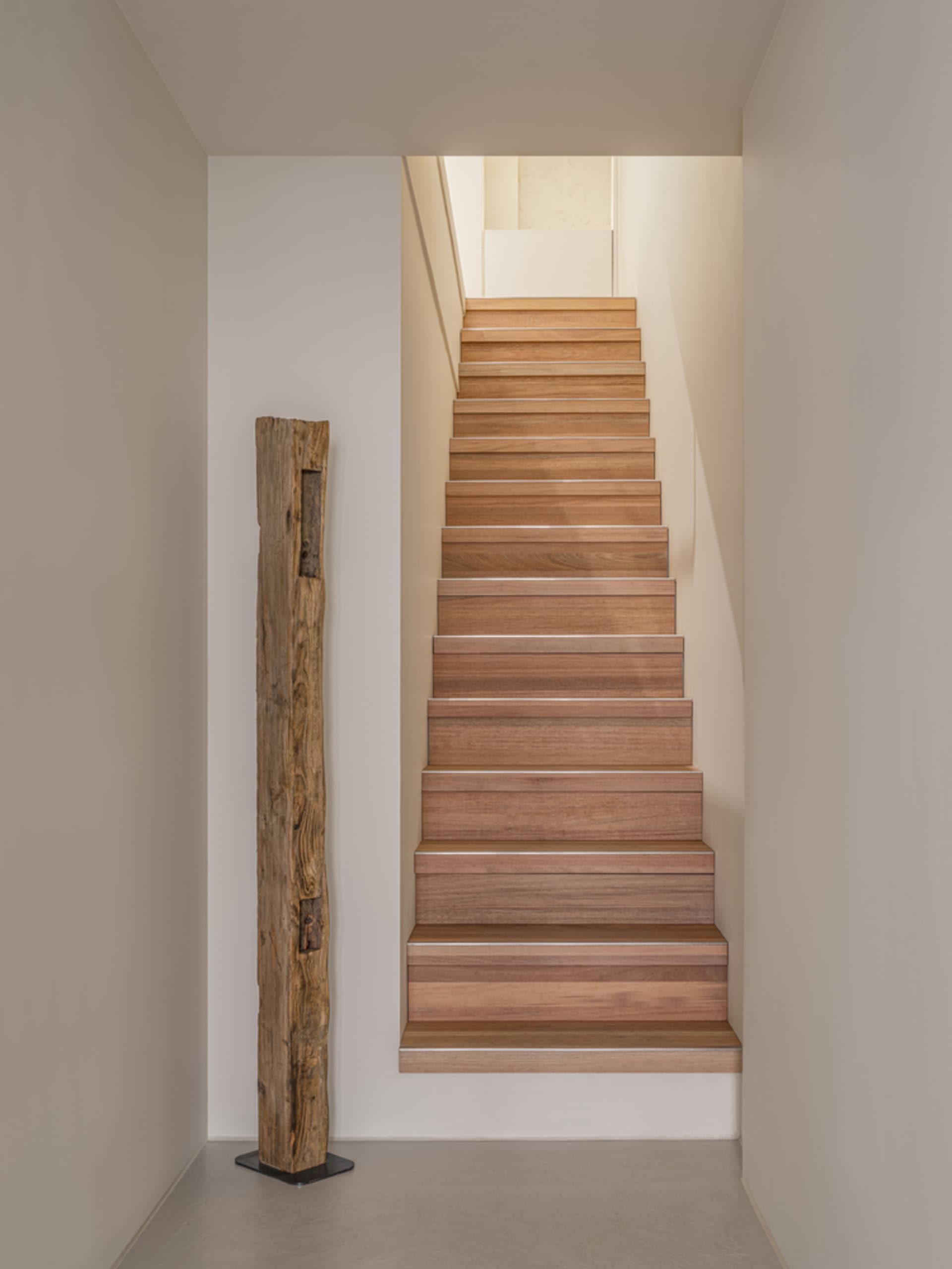 Modern staircase made of wood in an interior space.