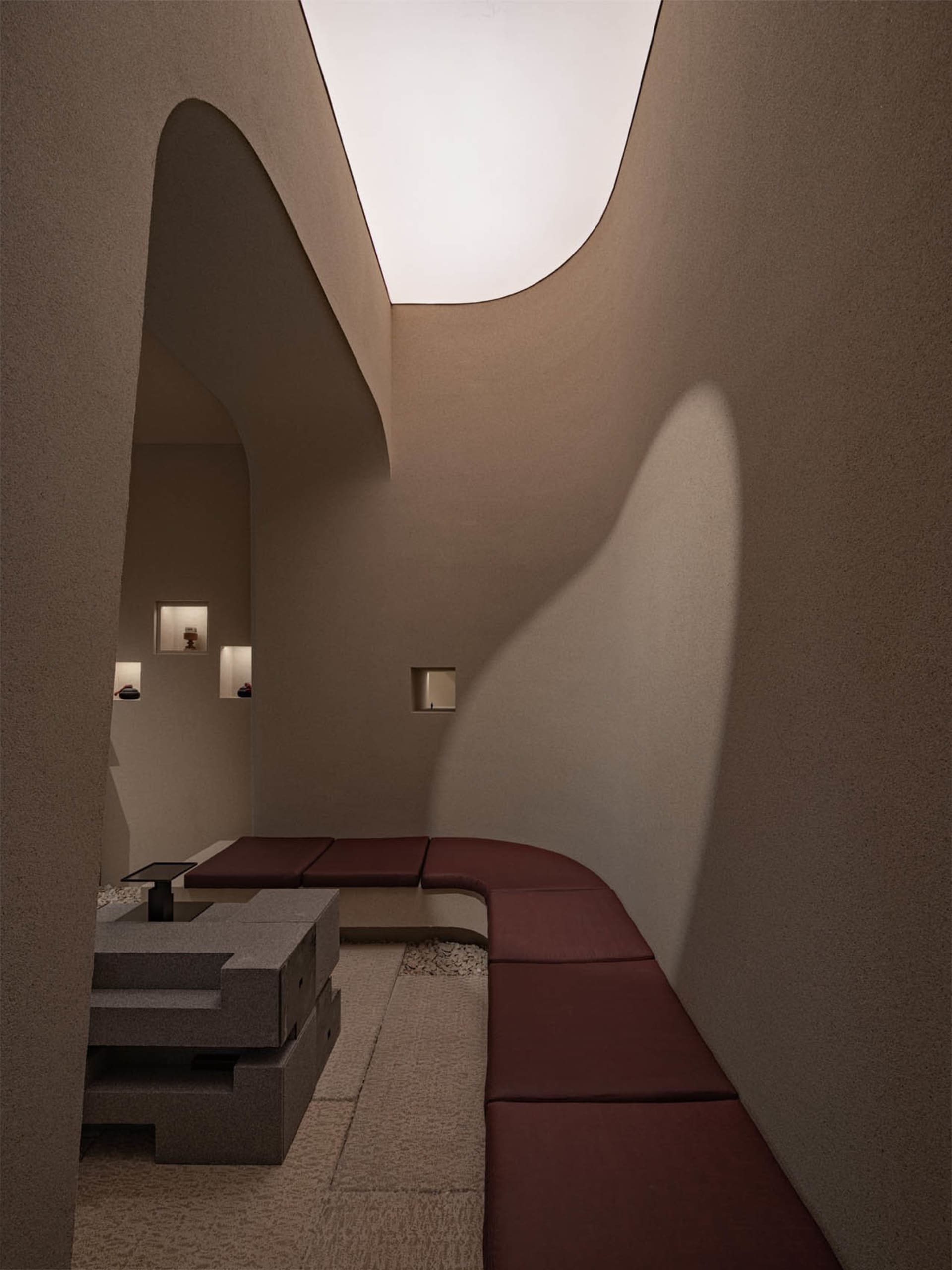 Modern interior design featuring concrete materials and minimalist furniture.