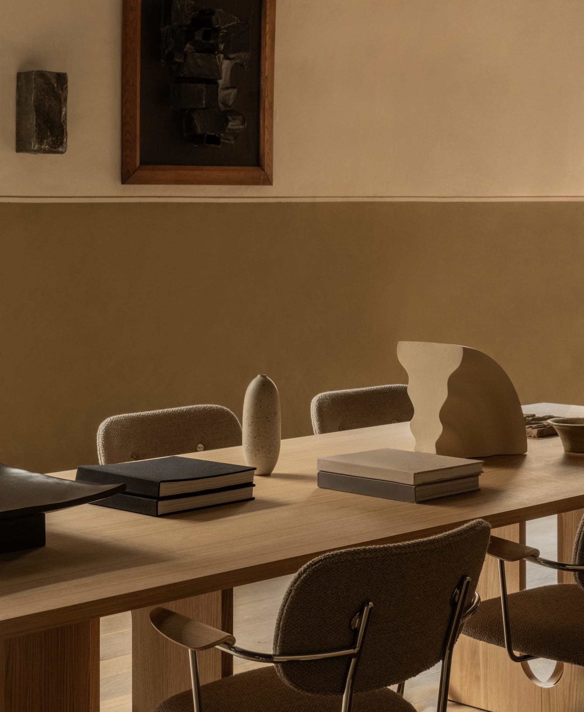 A modern dining room with wooden furniture and minimalist decor.