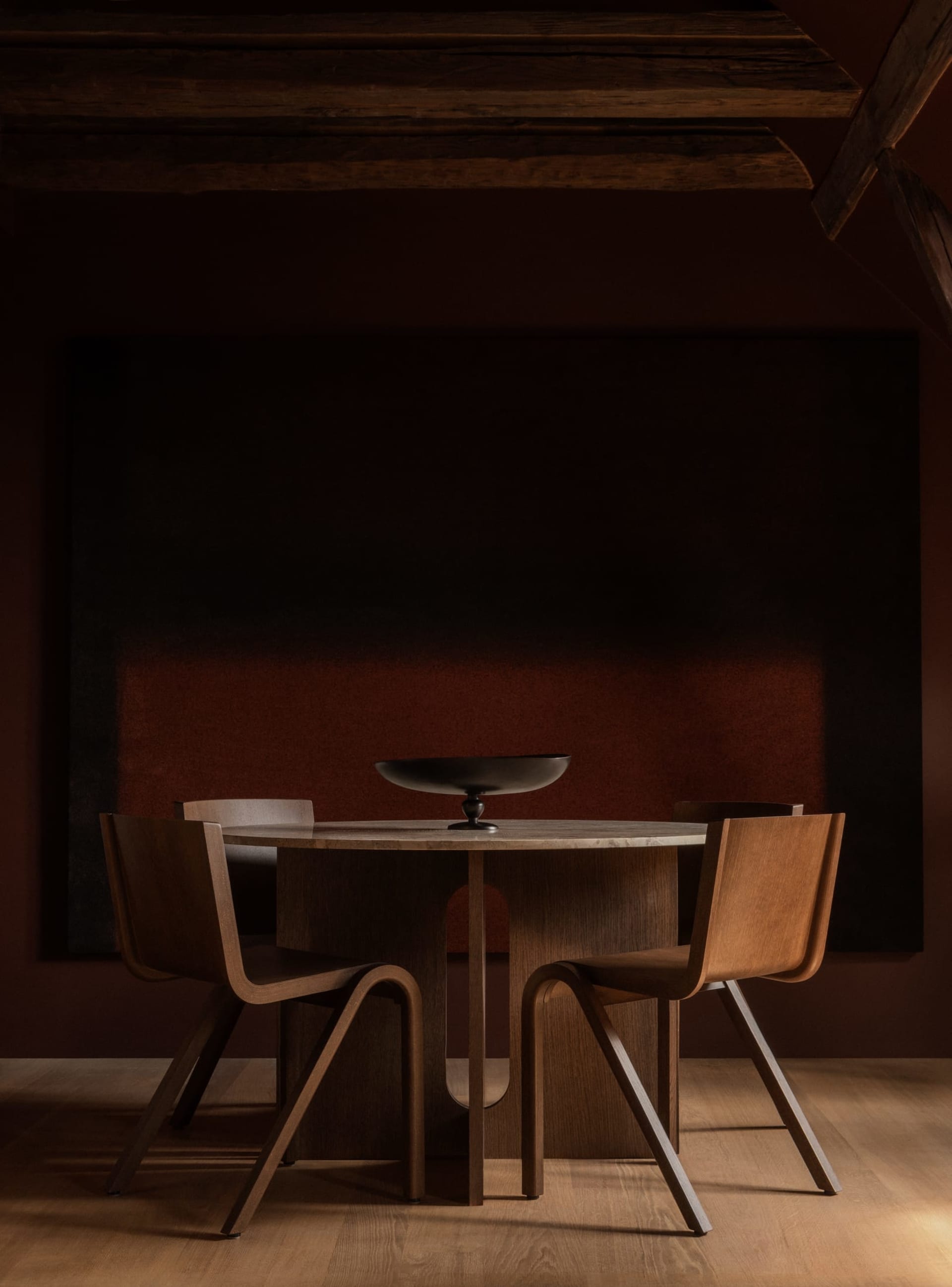 A modern, industrial-style dining area featuring wooden furniture and a minimalist design.