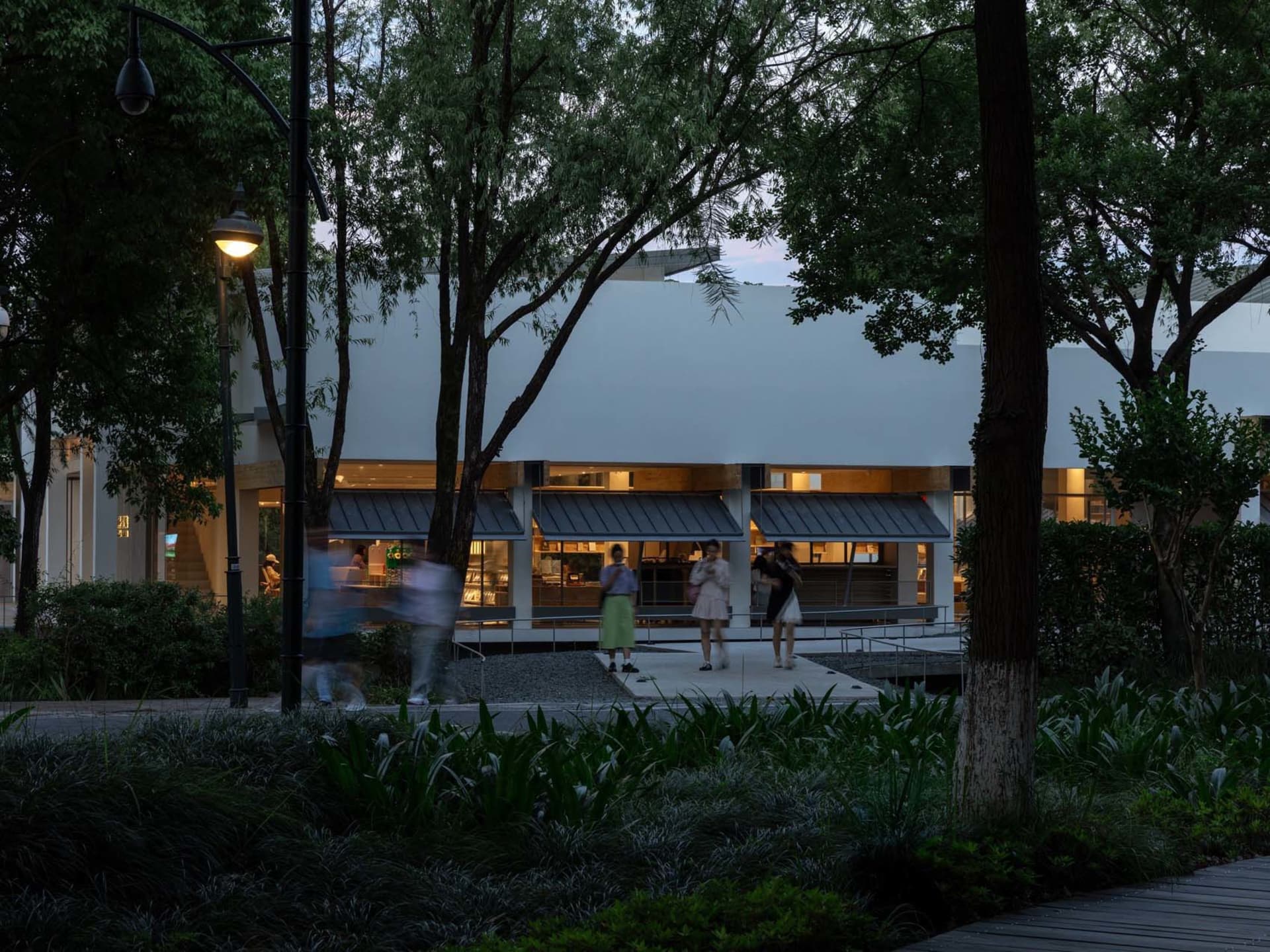 Modern public space with concrete architecture and greenery.