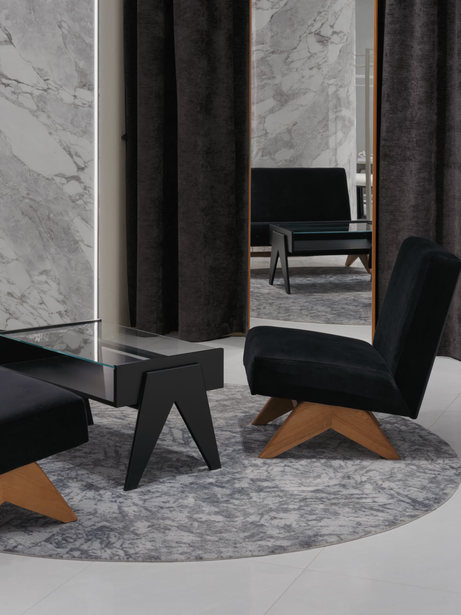 Modern living room with glass-tile flooring, minimalist decor, and large windows with dark curtains.