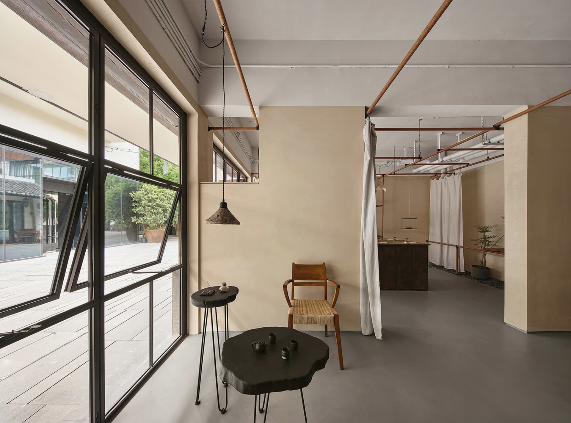 現代工業風格的客廳空間，搭配混凝土牆面與金屬燈具。