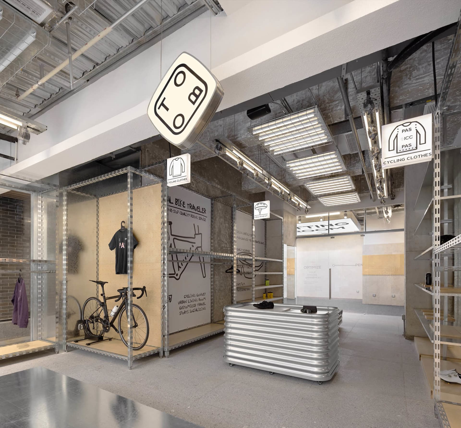 Modern industrial cycling store with metal shelves, glass displays, and concrete flooring.