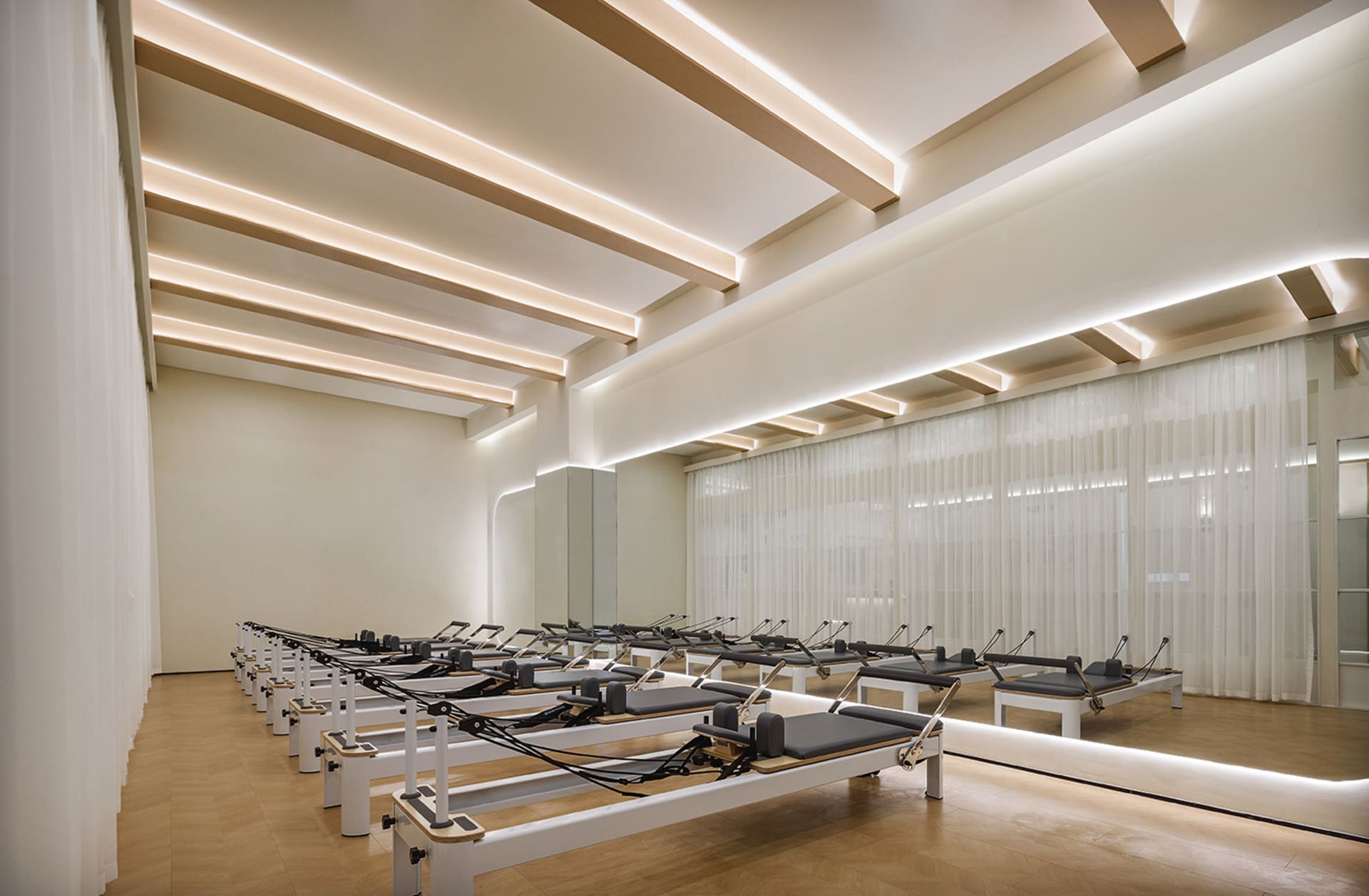 Modern, minimalist fitness center featuring wood elements