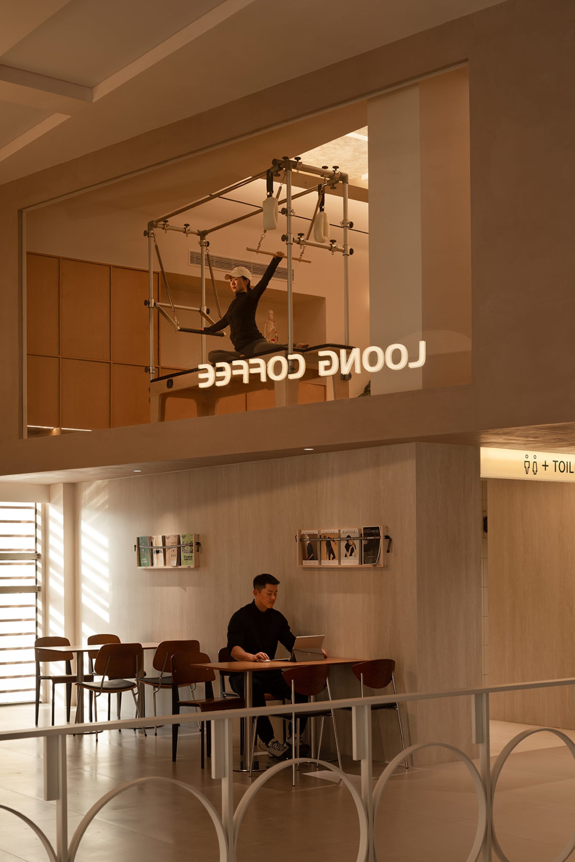 A modern coffee shop featuring industrial design elements, with a wooden counter and metal fixtures.