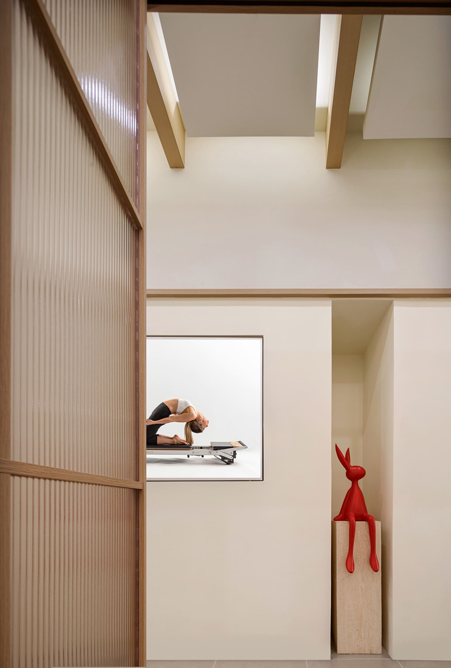 A modern fitness center with concrete ceilings and minimalist design features.